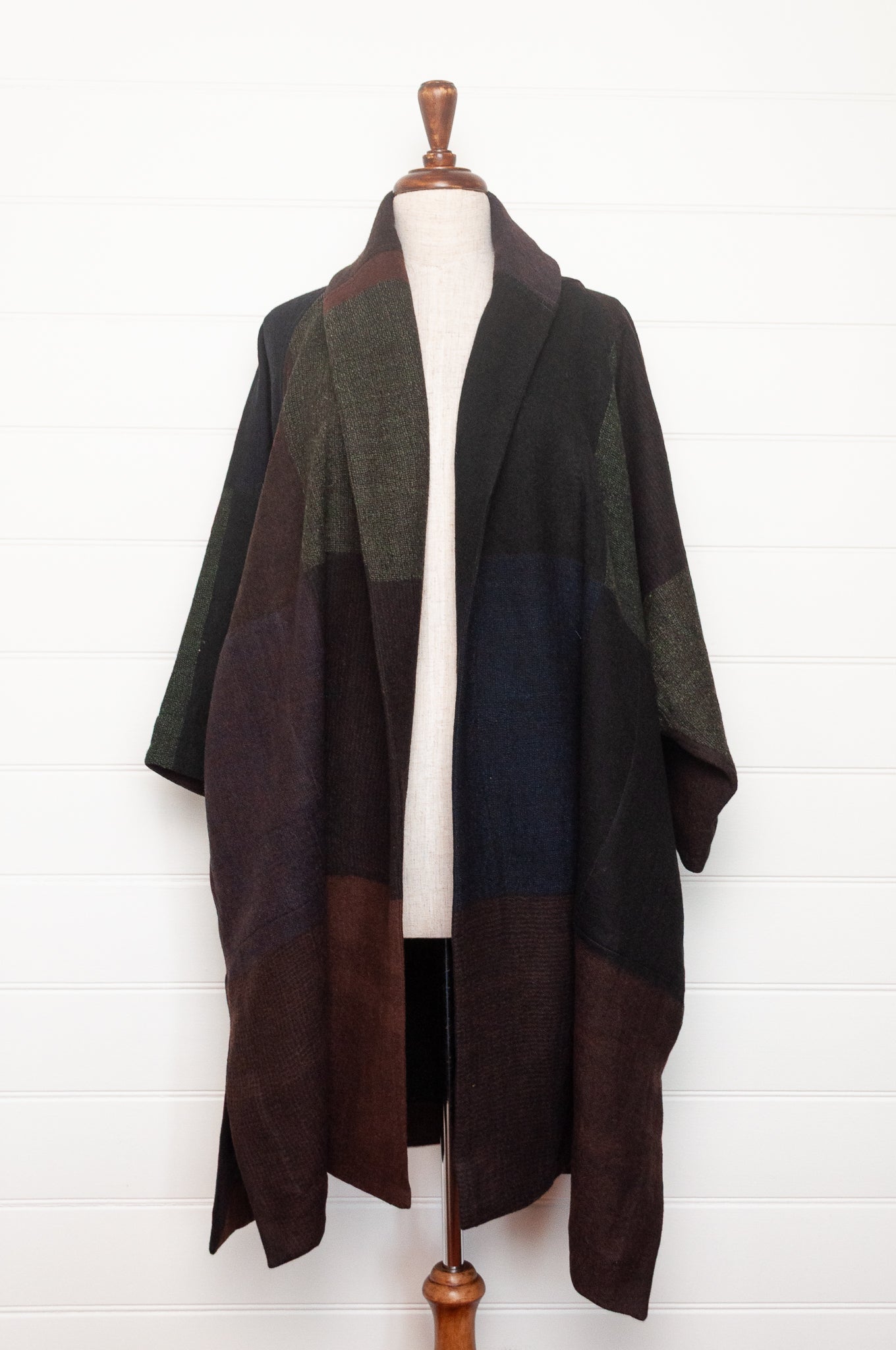 Neeru Kumar handwoven wool cardigan jacket coat in multicolor block pattern of charcoal, brown, aubergine purple, and black.