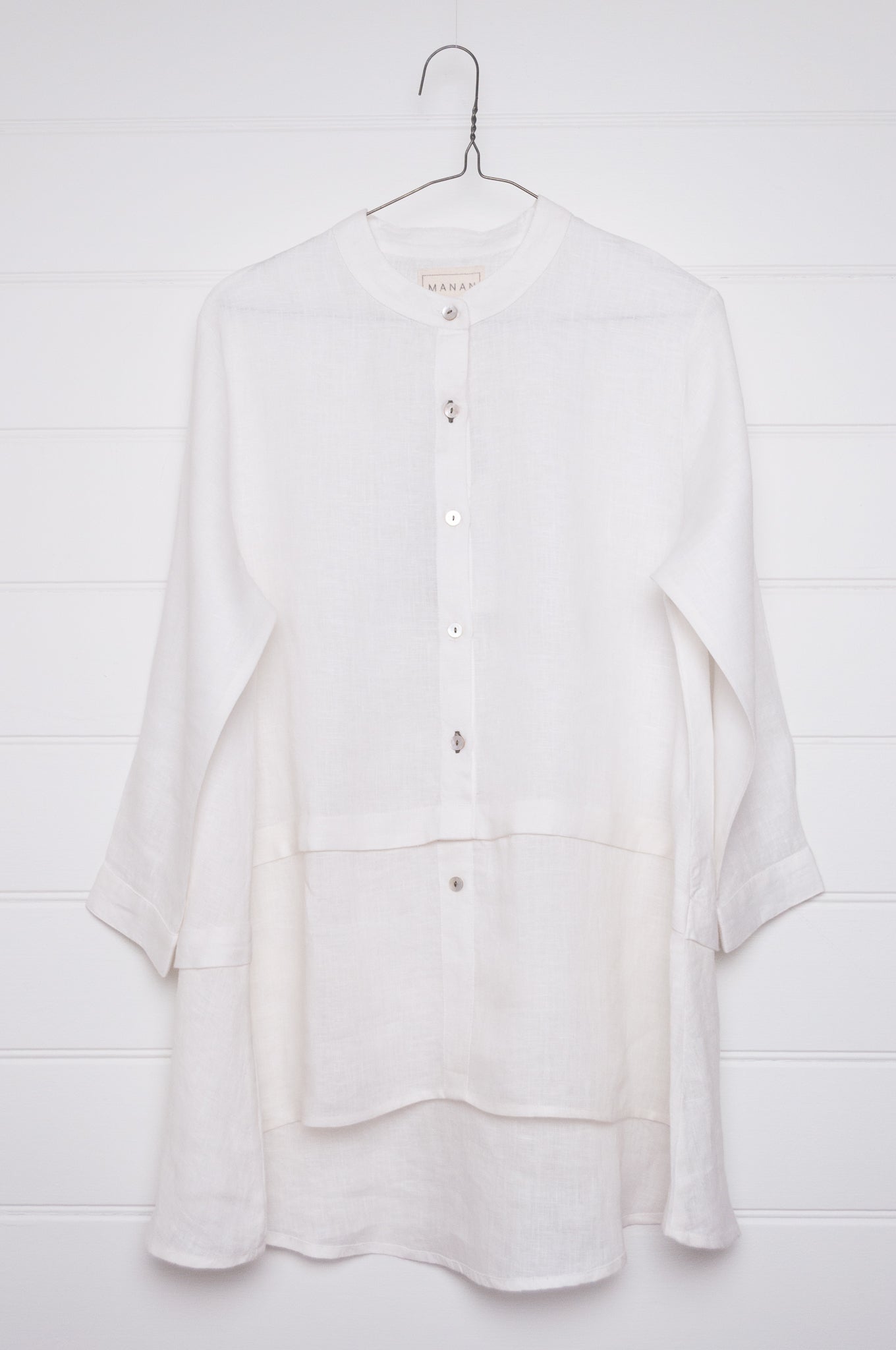 Manan Anaya white linen shirt with tailored seam detailing.