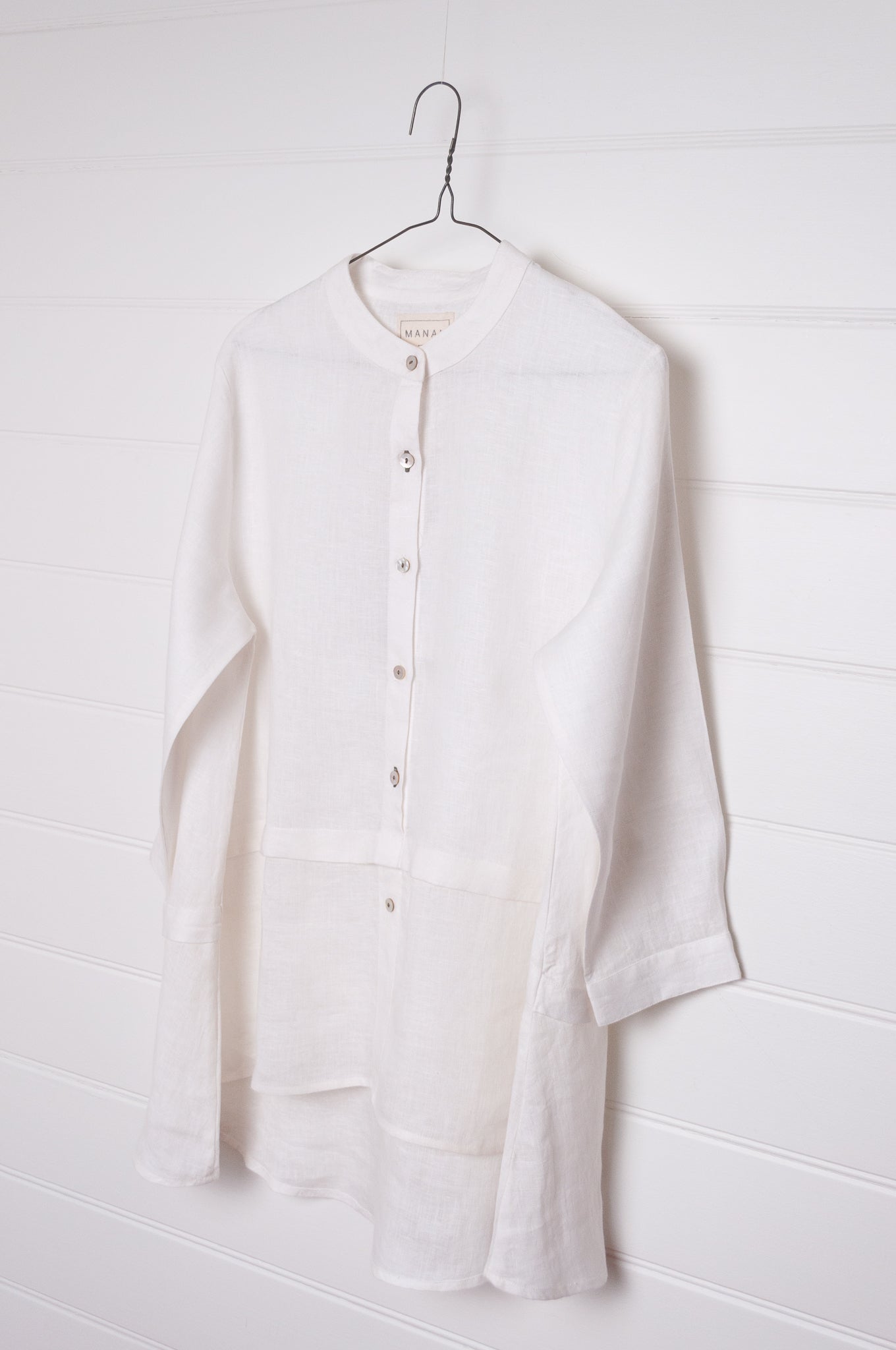Manan Anaya white linen shirt with tailored seam detailing.