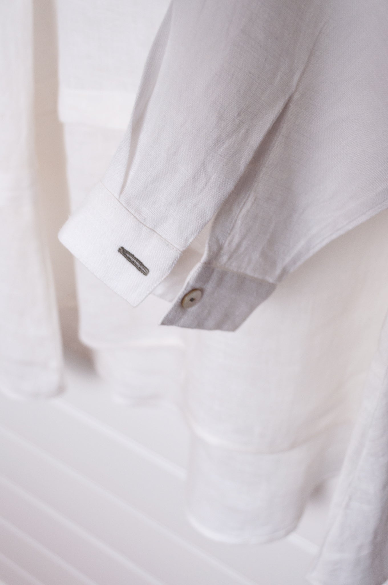 Manan Anaya white linen shirt with tailored seam detailing.