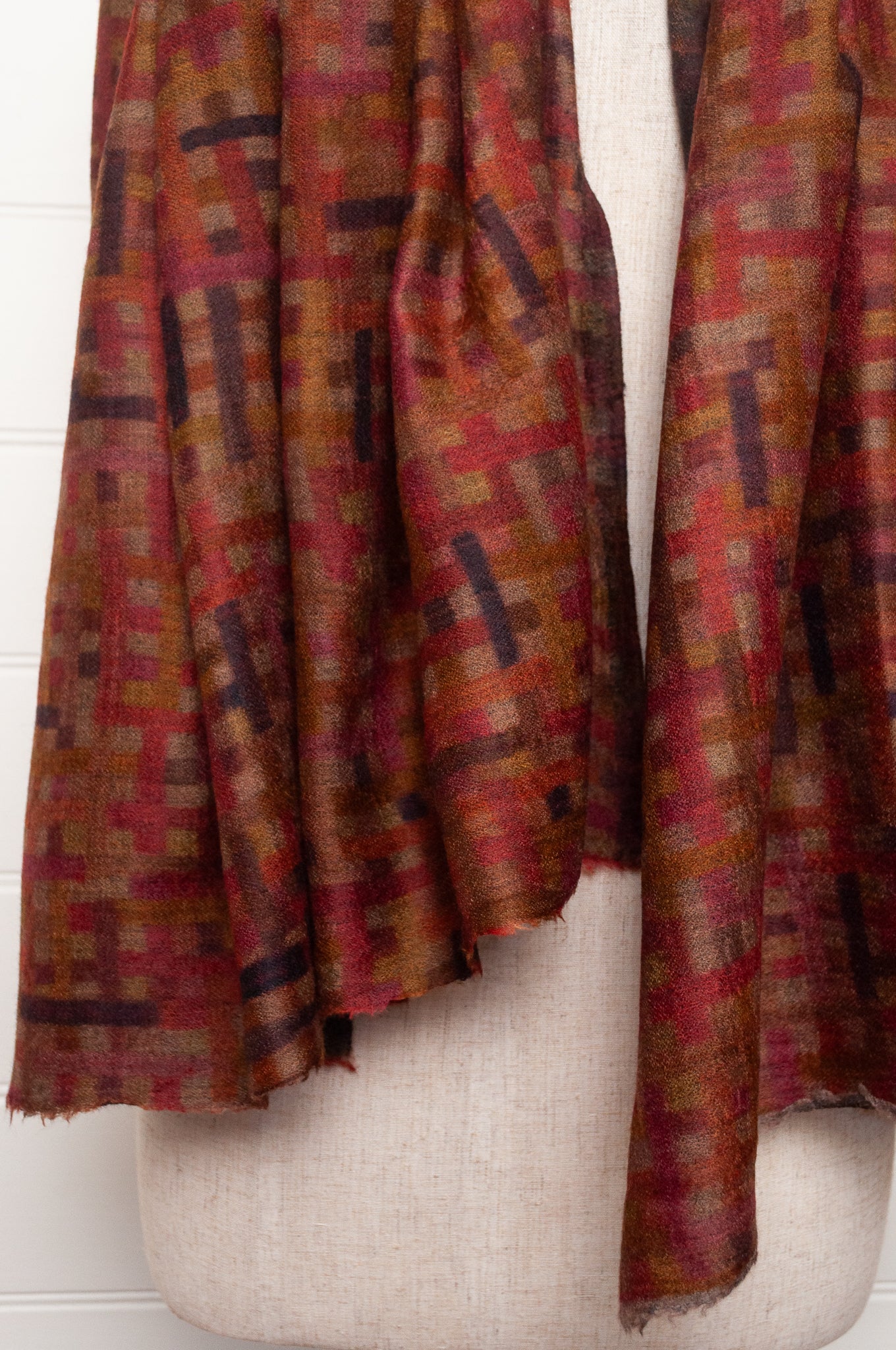 Neeru Kumar superfine wool scarf digital print check pattern in rust red, brown, and dark charcoal gray.