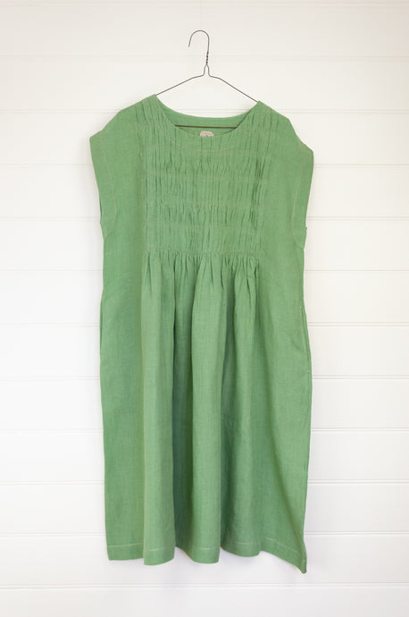 DVE Nayra dress in basil green linen, one size sleeveless with smocked bodice panel.