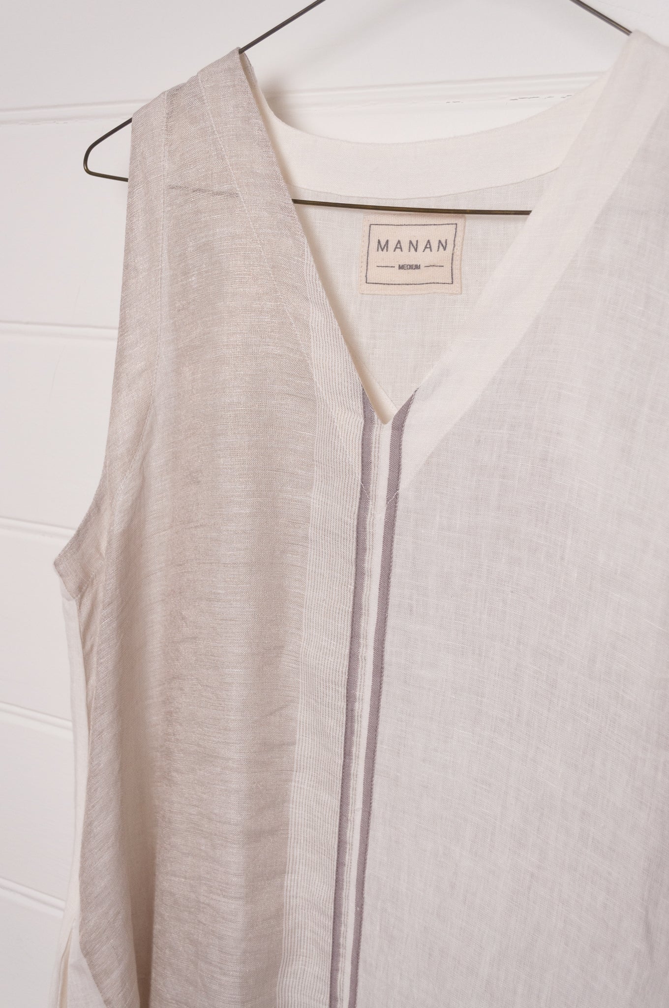 Manan Ayana V-neck sleeveless linen tunic dress with handwoven metallic border, stripe panels, selvedge detailing and hand-embroidery.