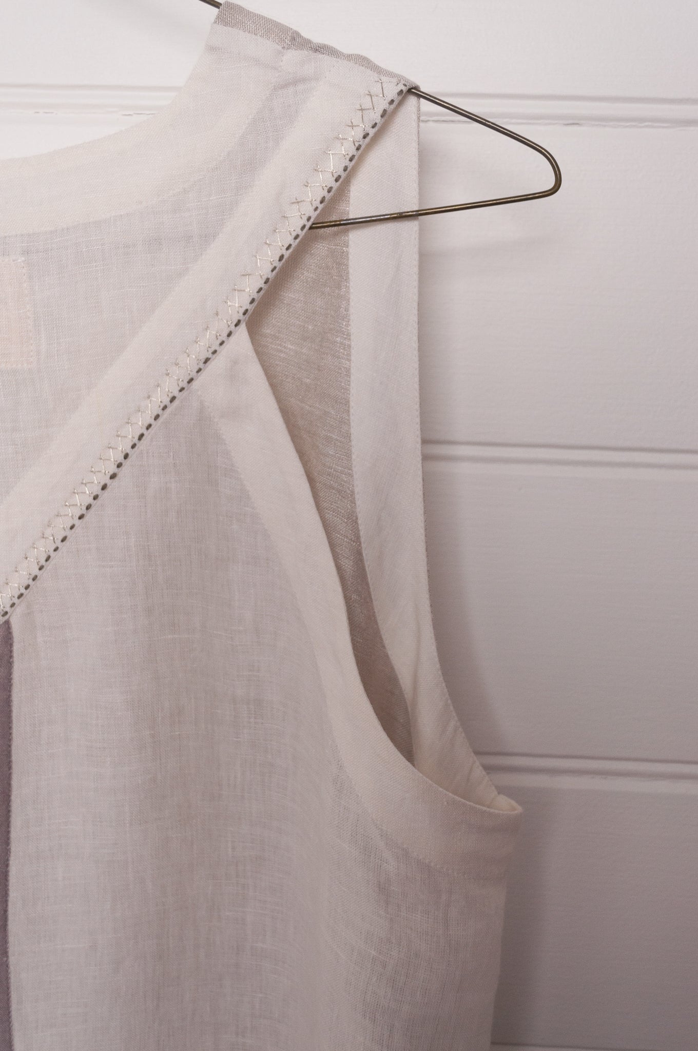 Manan Ayana V-neck sleeveless linen tunic dress with handwoven metallic border, stripe panels, selvedge detailing and hand-embroidery.