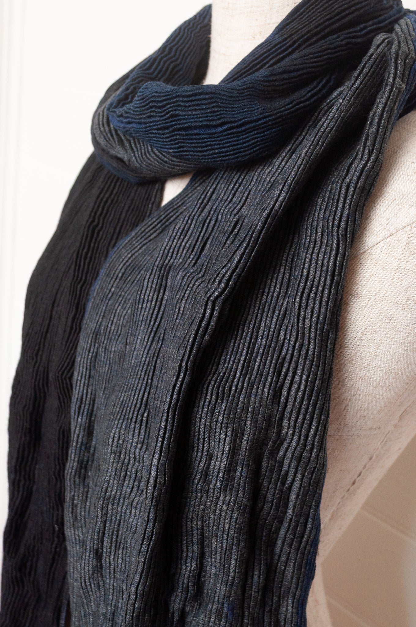 Neeru Kumar pure wool shibori dyed crinkle pleat finish scarf in indigo blue, and charcoal grey.