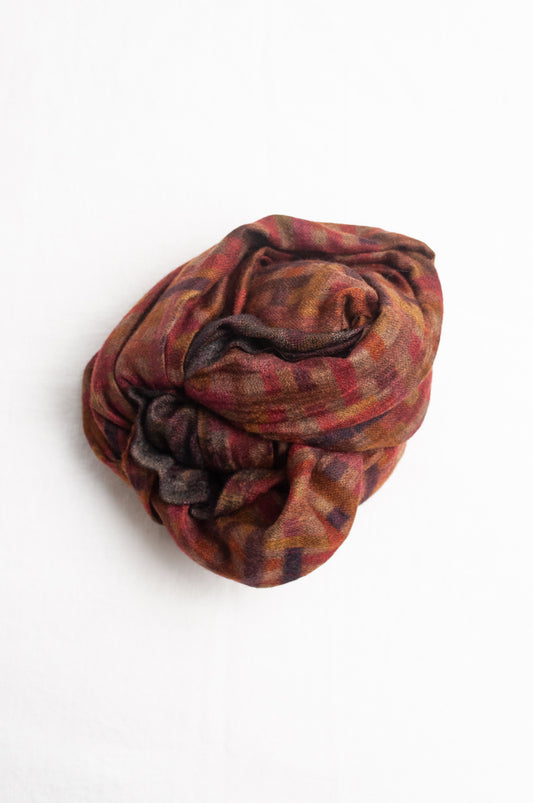 Neeru Kumar superfine wool scarf digital print check pattern in rust red, brown, and dark charcoal gray.
