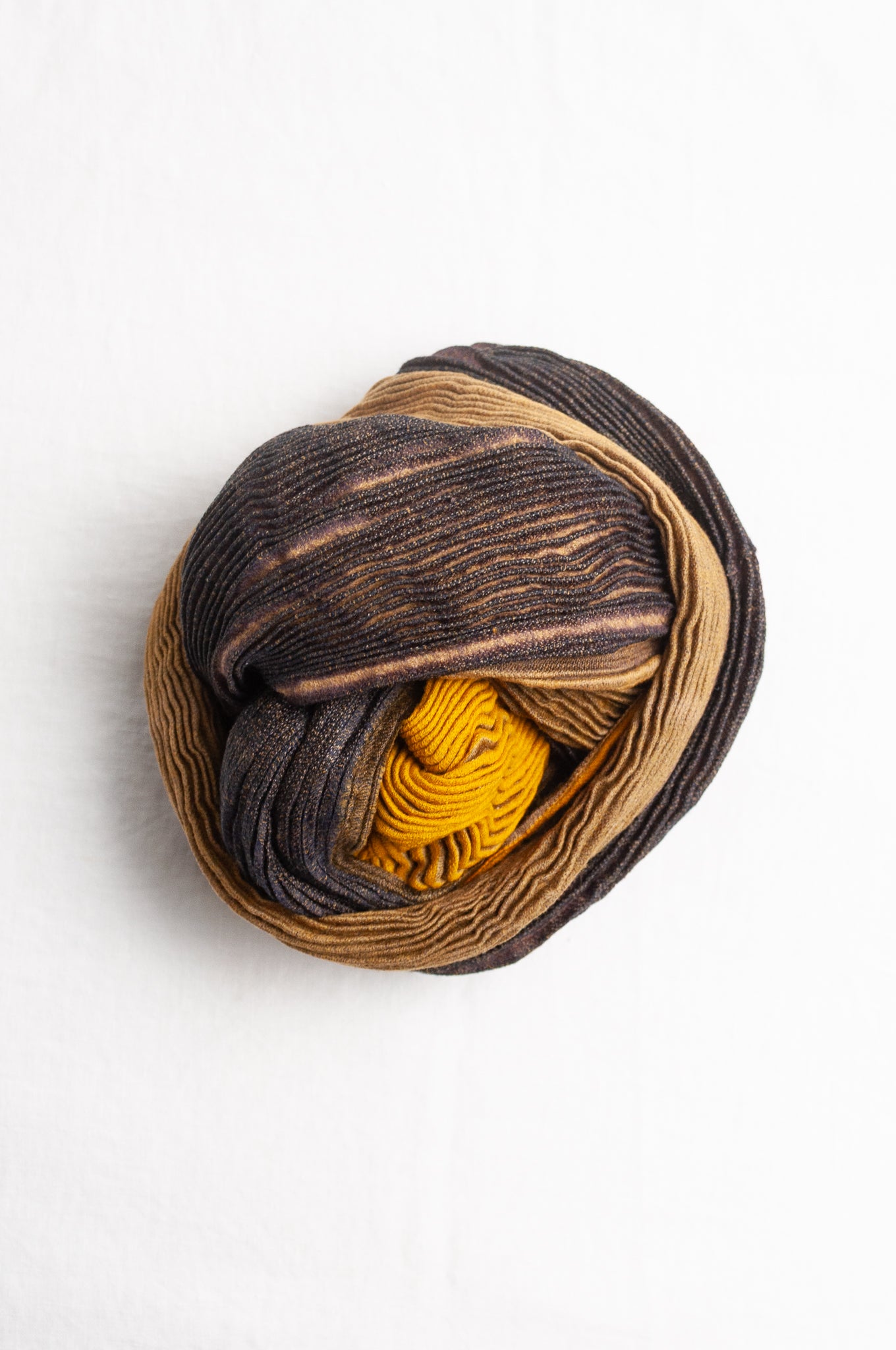 Neeru Kumar pure wool shibori dyed crinkle pleat finish scarf in gold and brown.