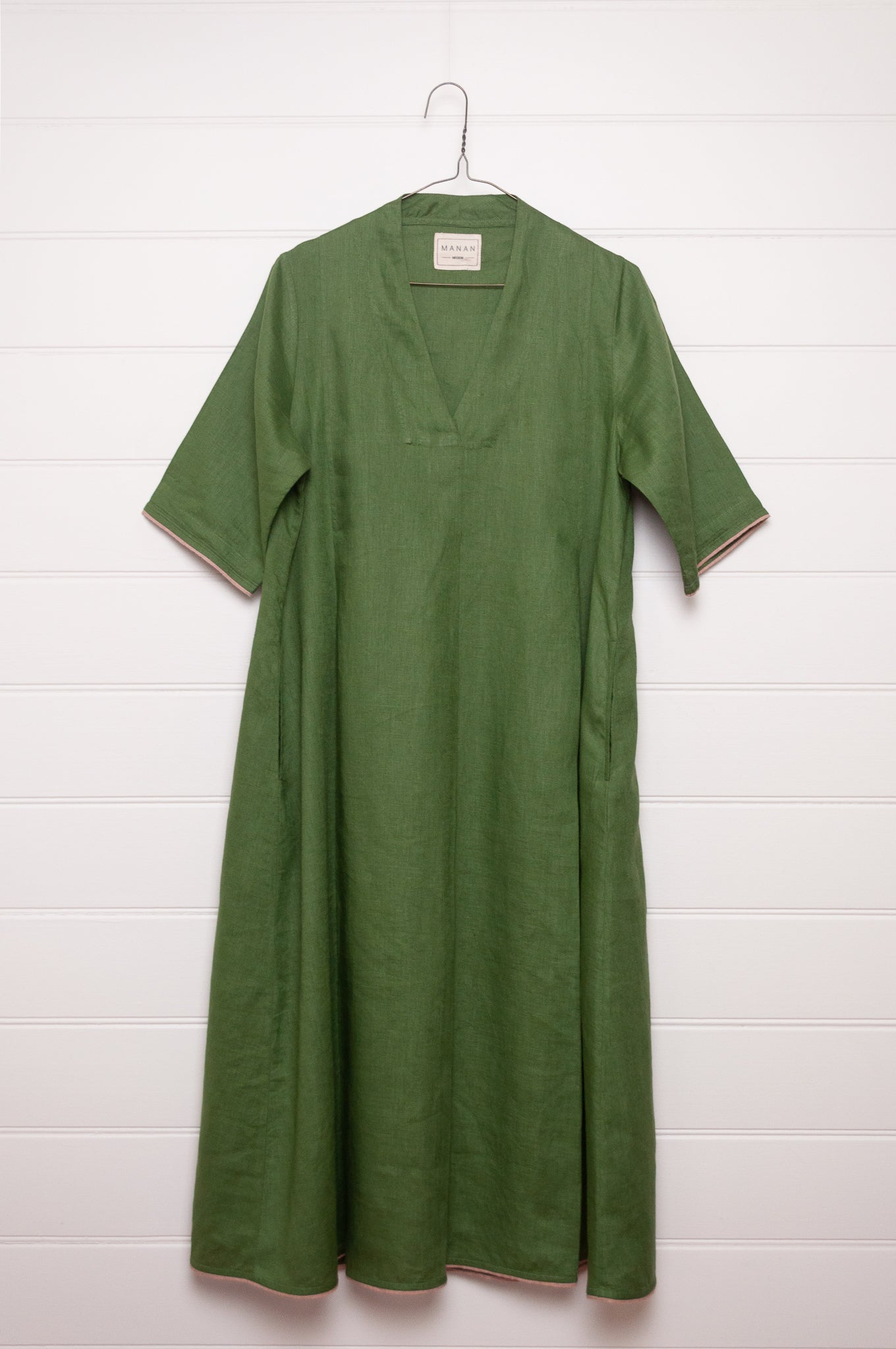 Manan Maki pleated linen short sleeve dress with V-neck in green.