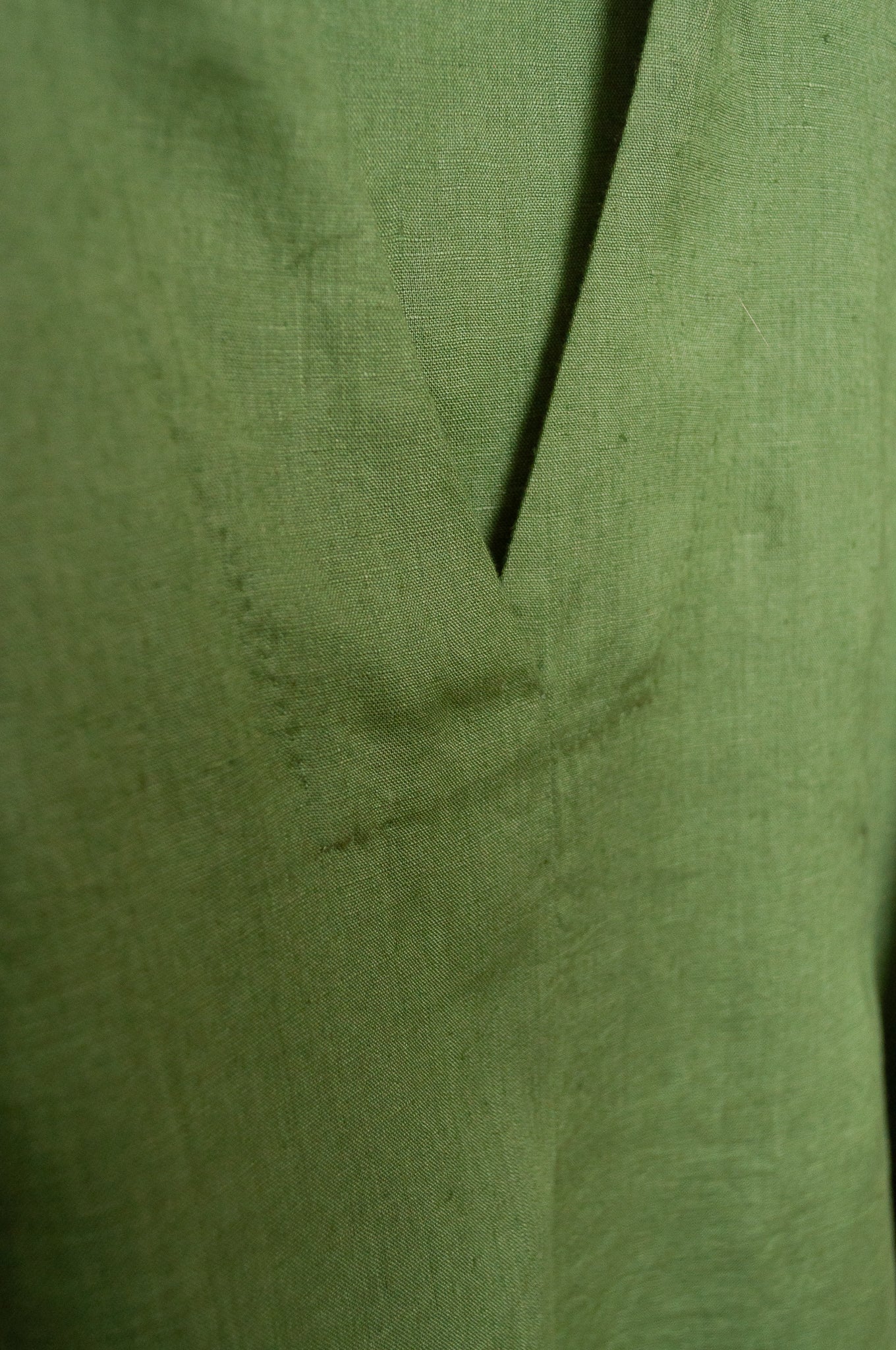 Manan Maki pleated linen short sleeve dress with V-neck in green.