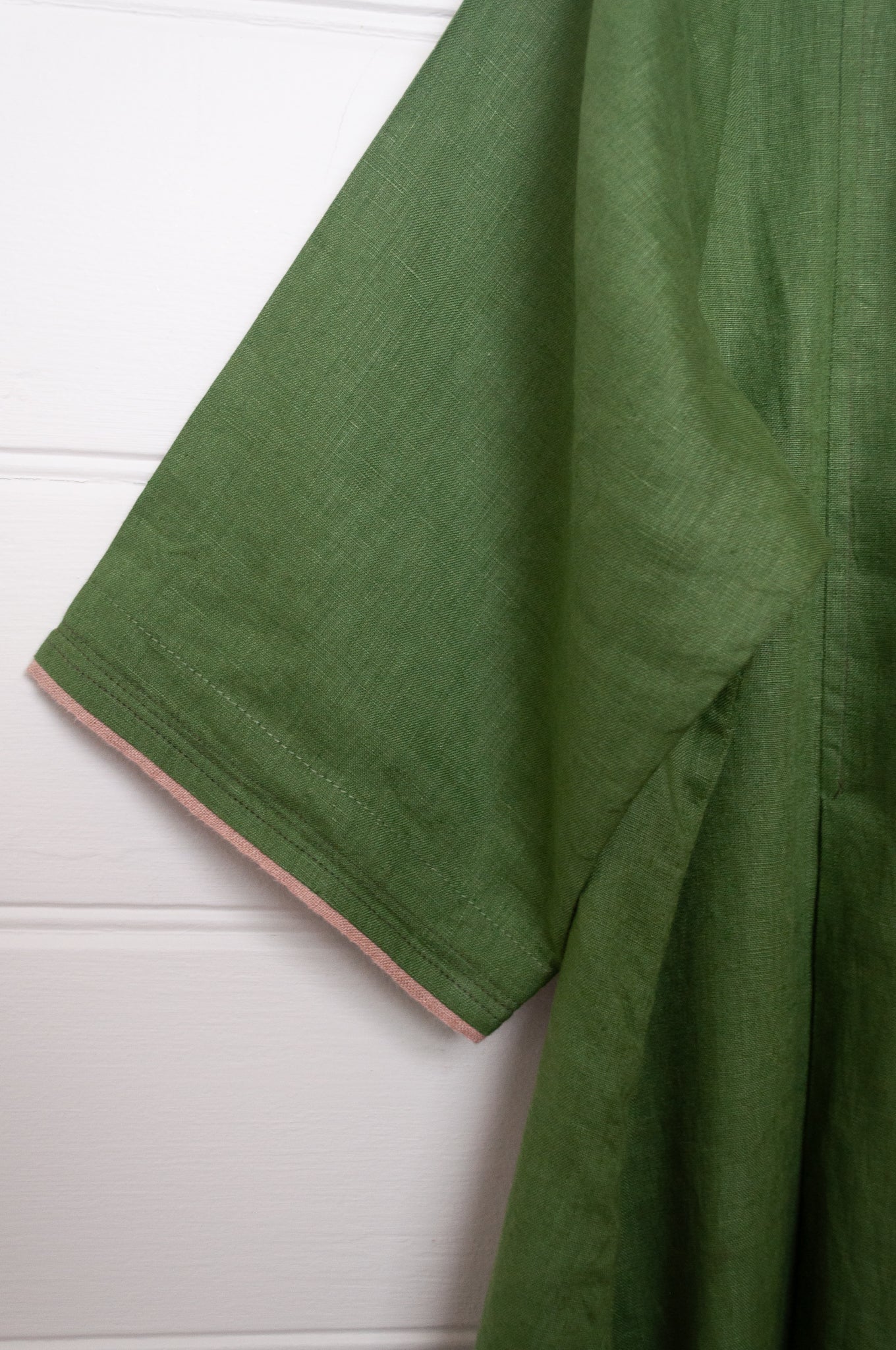 Manan Maki pleated linen short sleeve dress with V-neck in green.
