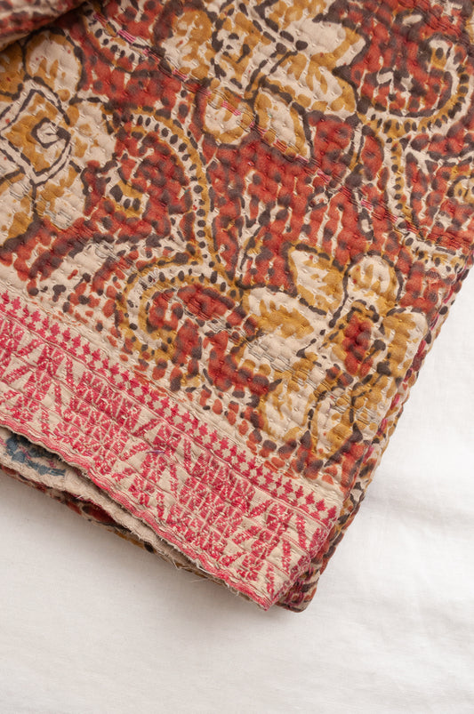Vintage bagru blockprinted kantha quilt, floral design in rust red and mustard yellow, with red traditional decorative embroidery