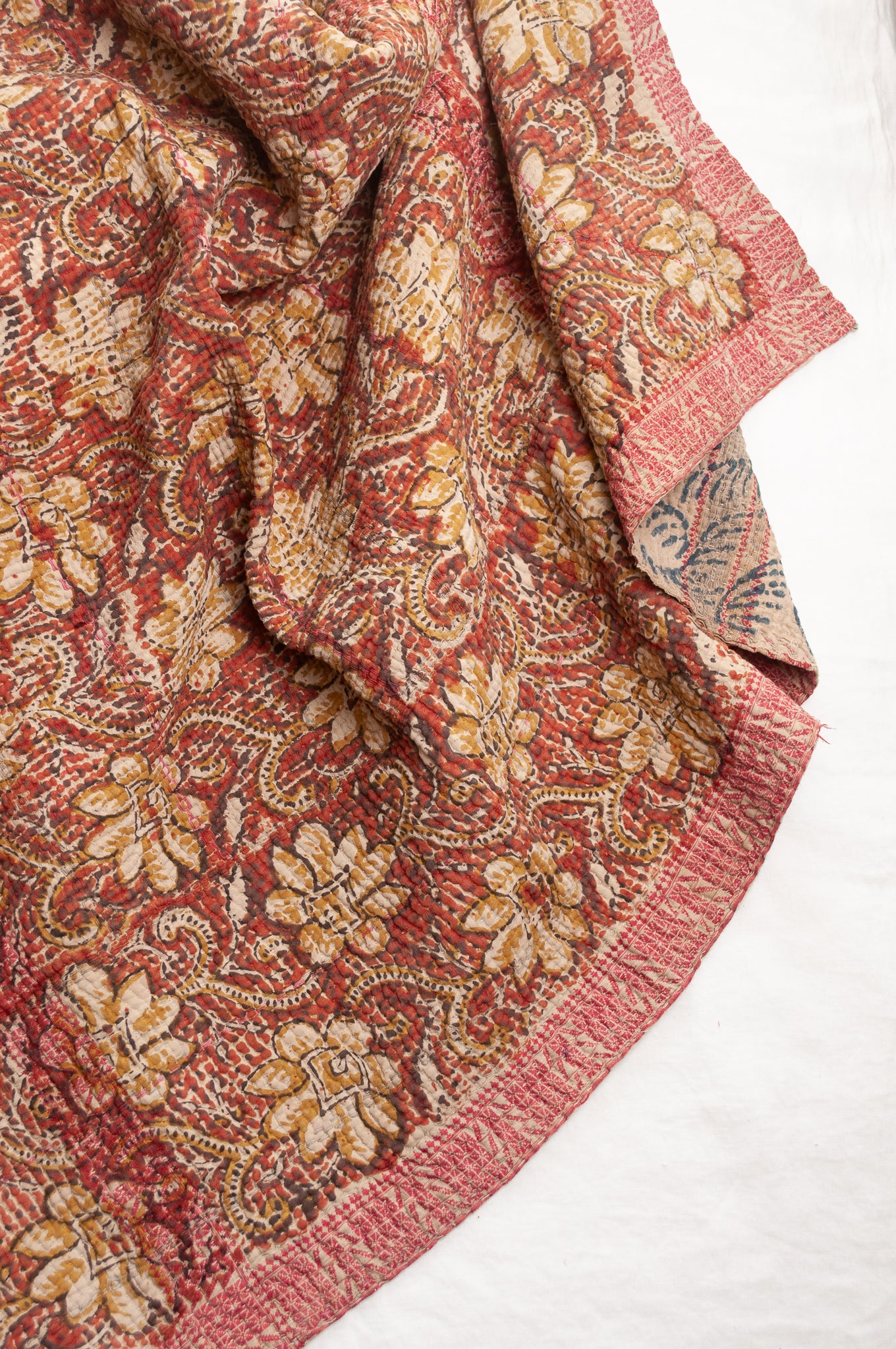 Vintage bagru blockprinted kantha quilt, floral design in rust red and mustard yellow, with red traditional decorative embroidery