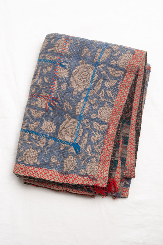 Vintage kantha quilt Bagru blockprinted in indigo floral design with red and cobalt blue embroidery.