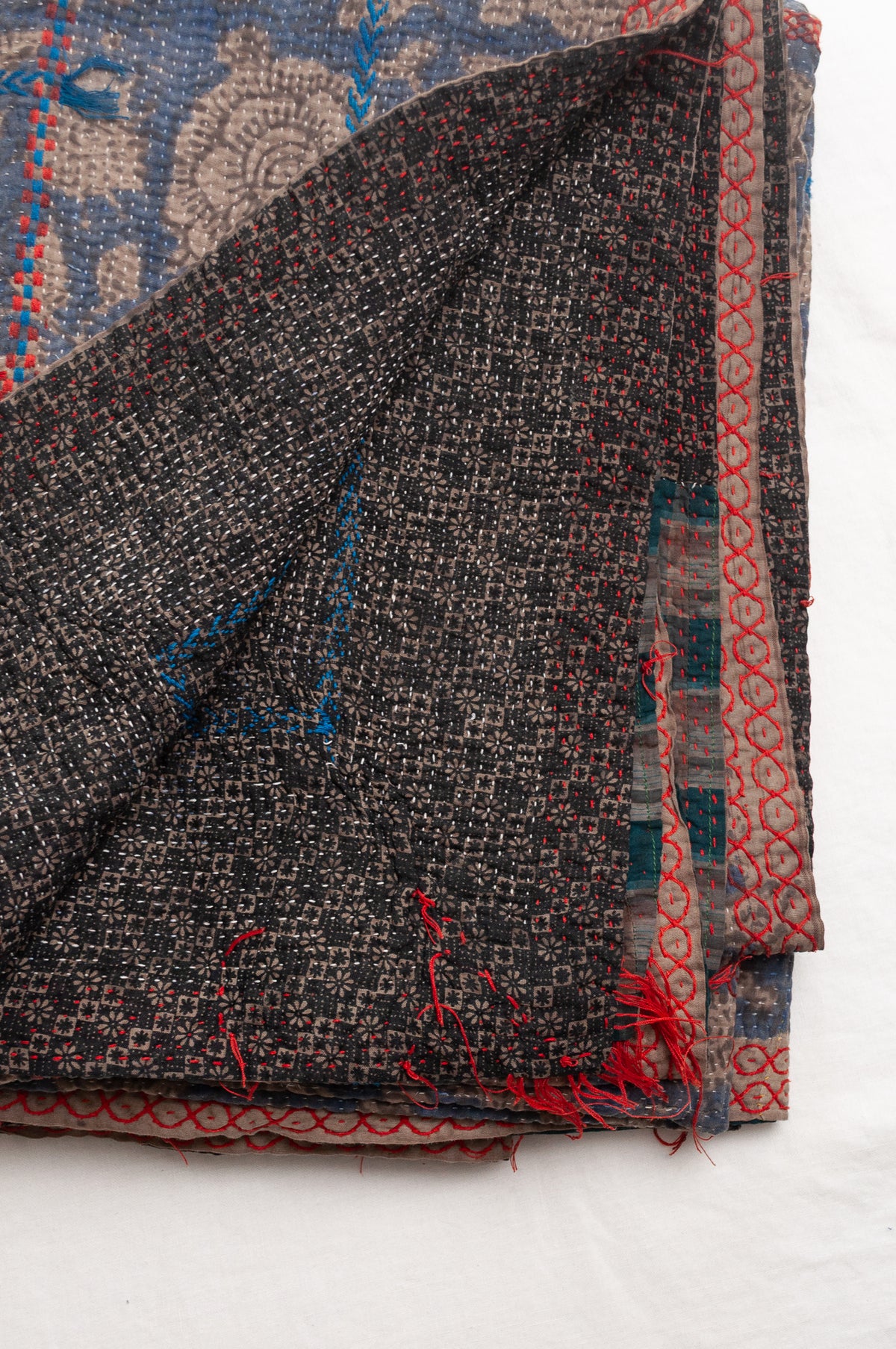 Vintage kantha quilt Bagru blockprinted in indigo floral design with red and cobalt blue embroidery.