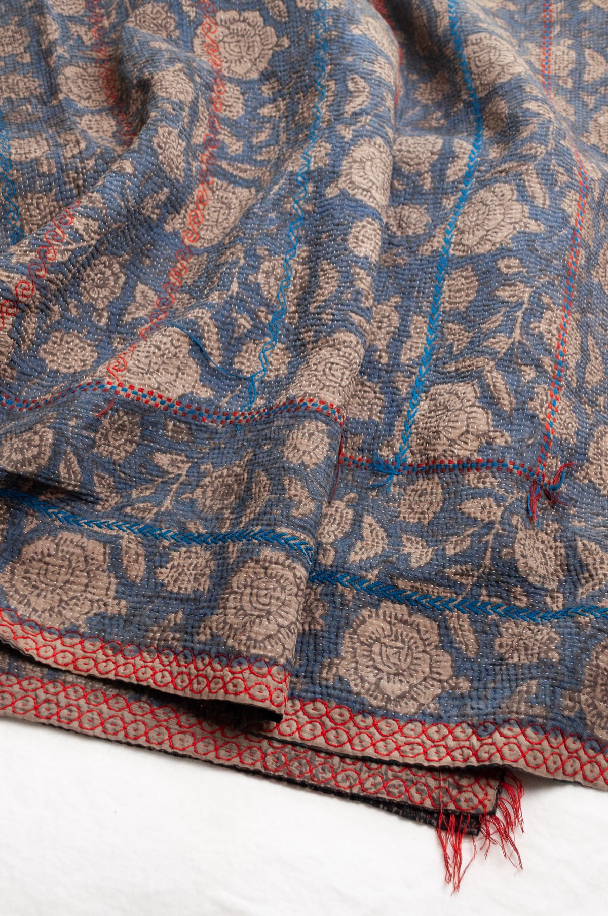 Vintage kantha quilt Bagru blockprinted in indigo floral design with red and cobalt blue embroidery.