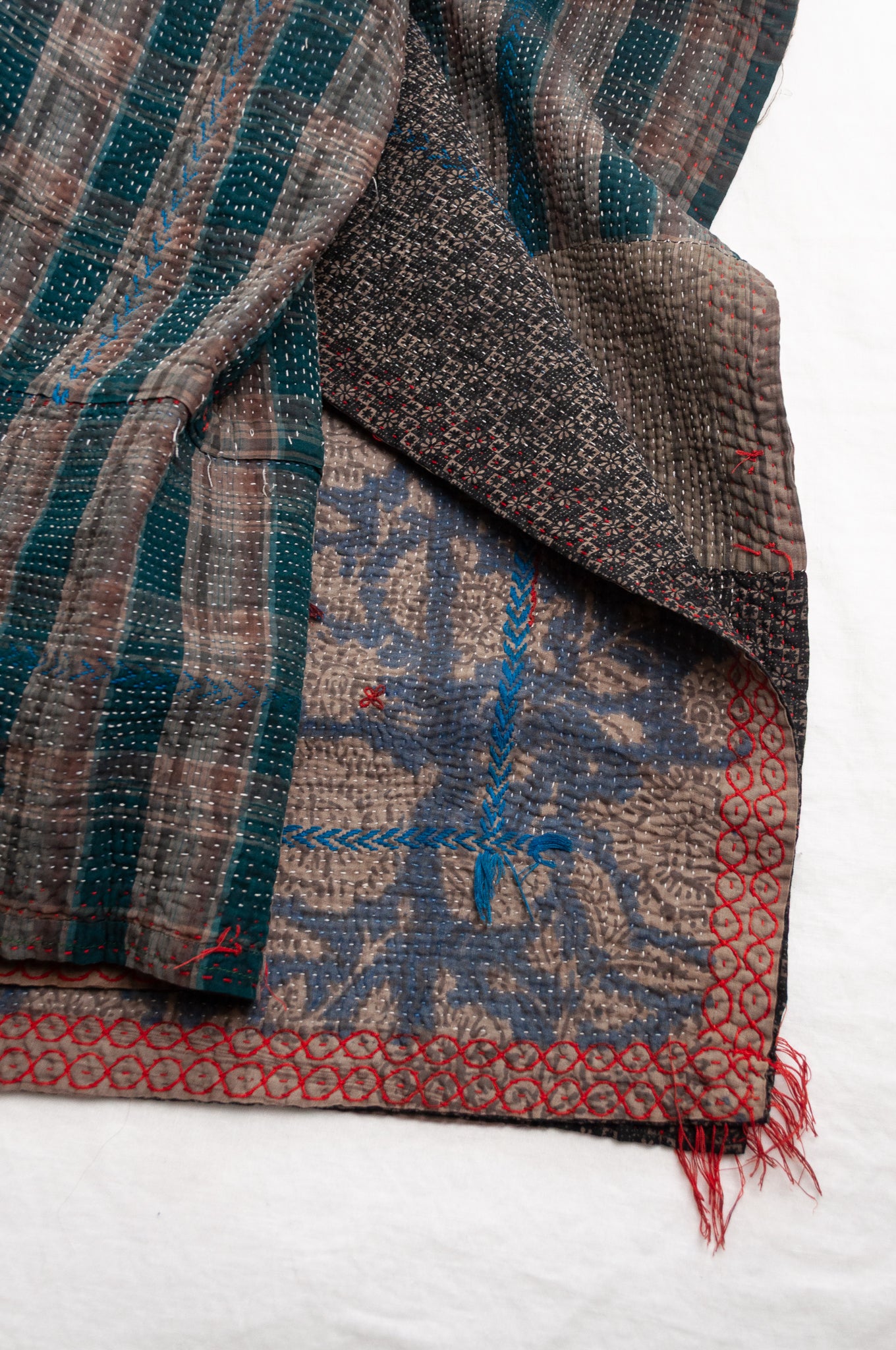 Vintage kantha quilt Bagru blockprinted in indigo floral design with red and cobalt blue embroidery.