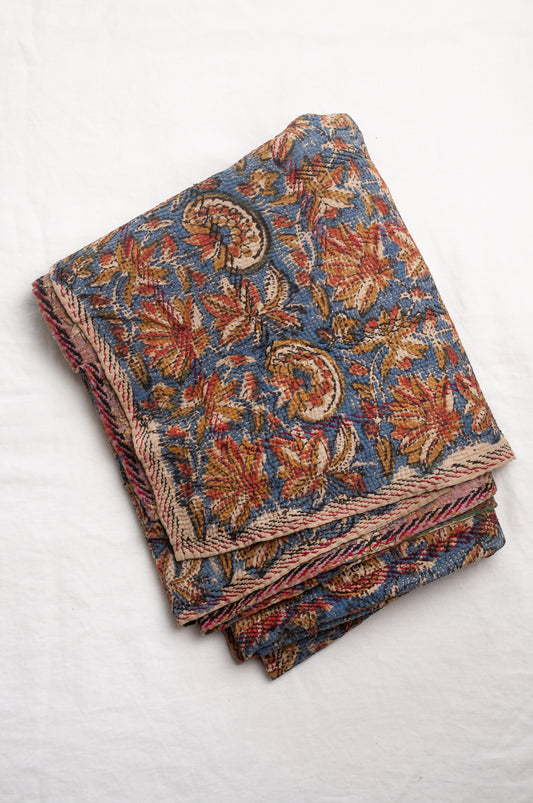 Vintage kantha quilt Bagru blockprinted in indigo, mustard and rust brown, floral design with red and dark green embroidery.