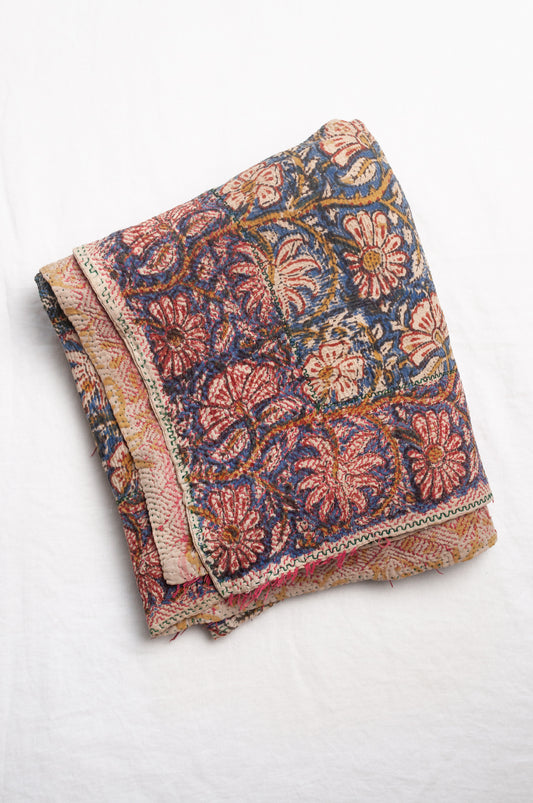 Vintage kantha quilt Bagru blockprinted in indigo and rust brown, floral design with red braid edging embroidery.