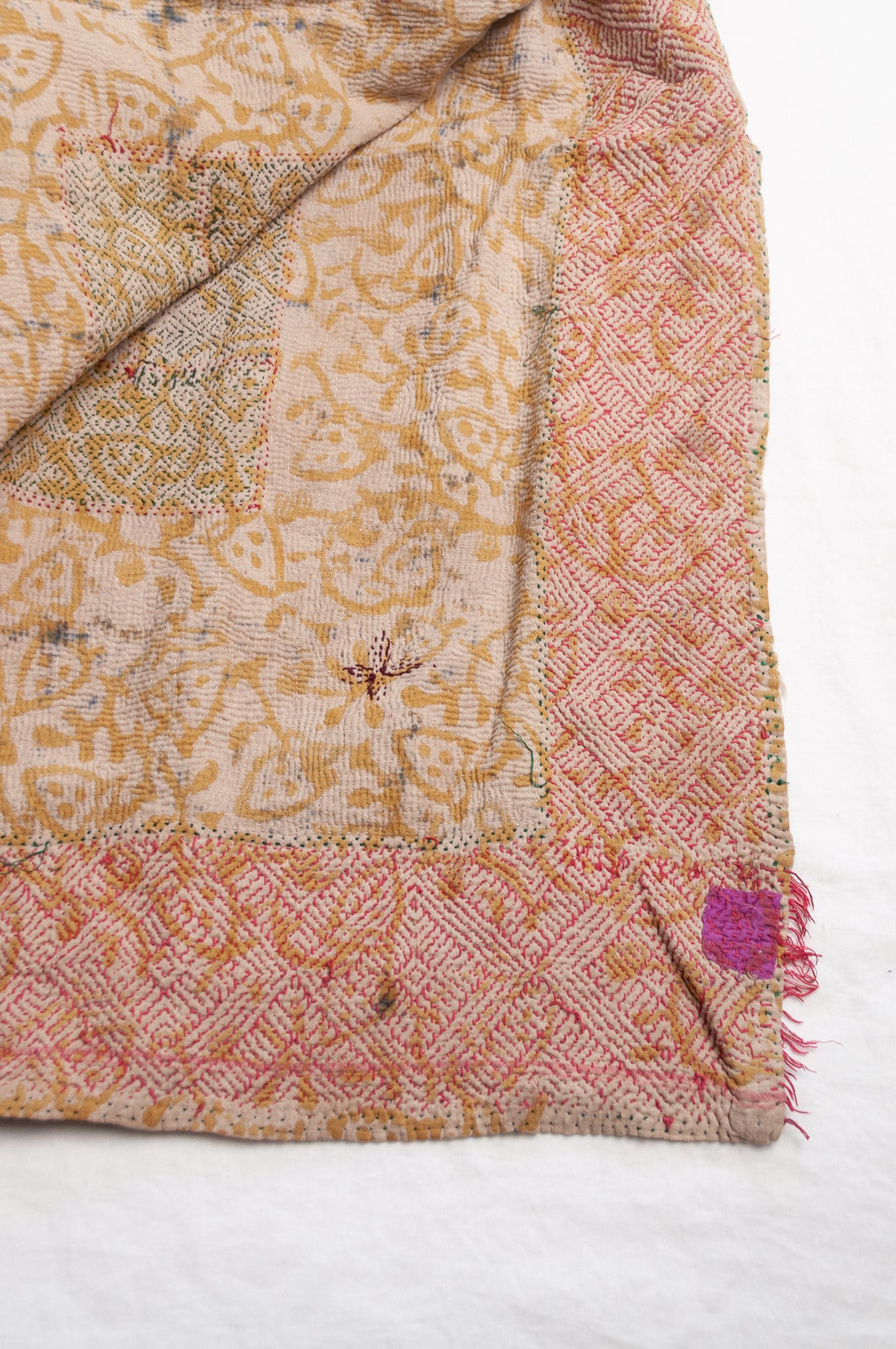 Vintage kantha quilt Bagru blockprinted in indigo and rust brown, floral design with red braid edging embroidery.