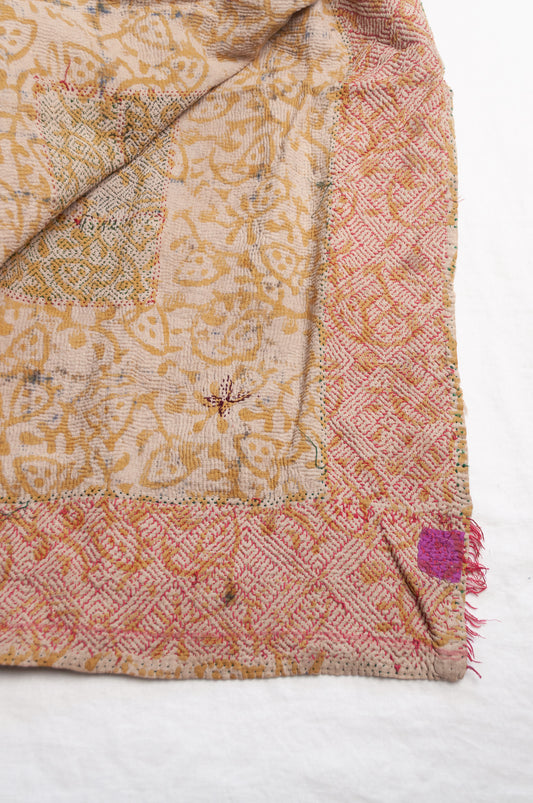 Vintage kantha quilt Bagru blockprinted in indigo and rust brown, floral design with red braid edging embroidery.