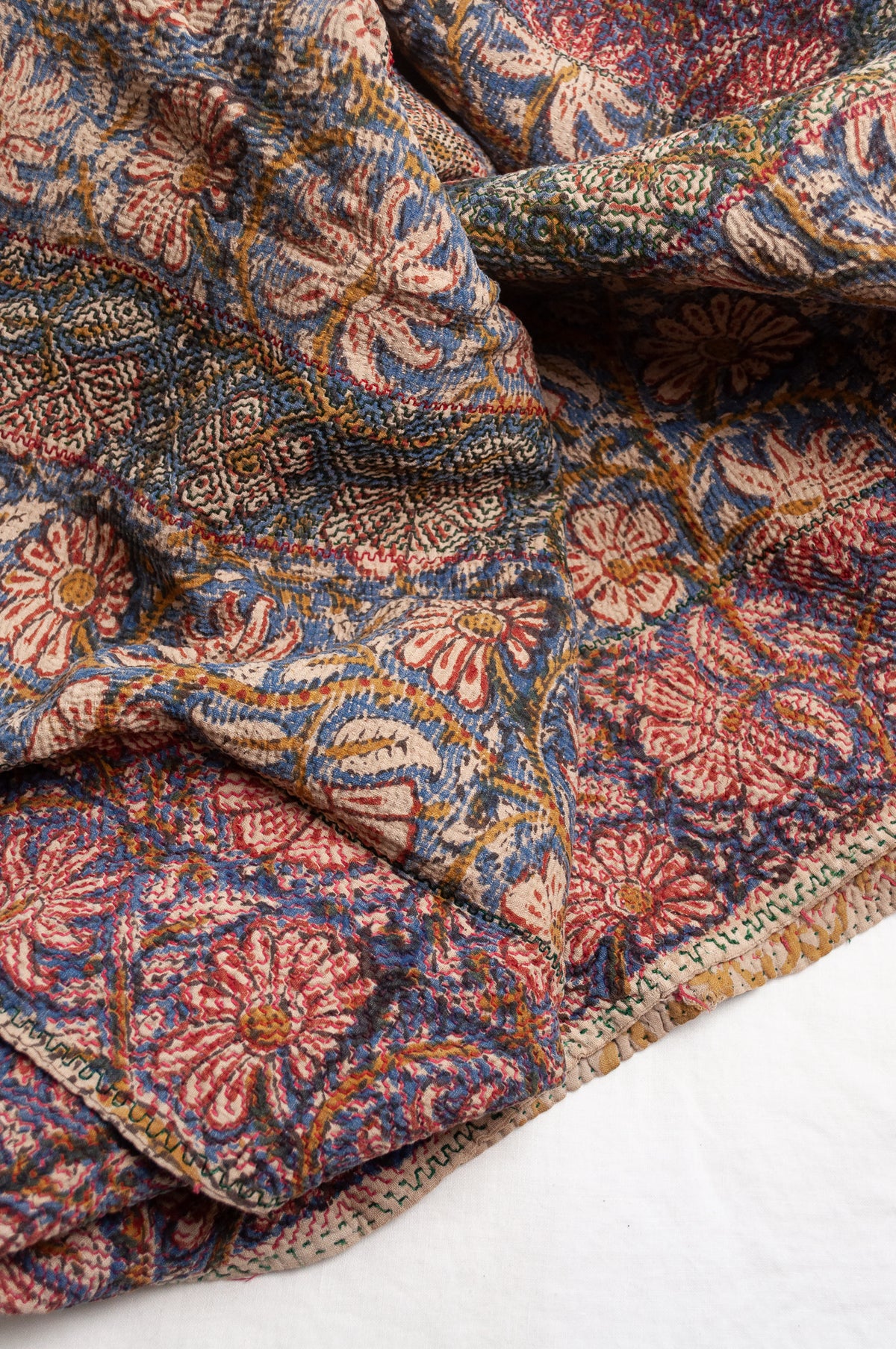 Vintage kantha quilt Bagru blockprinted in indigo and rust brown, floral design with red braid edging embroidery.