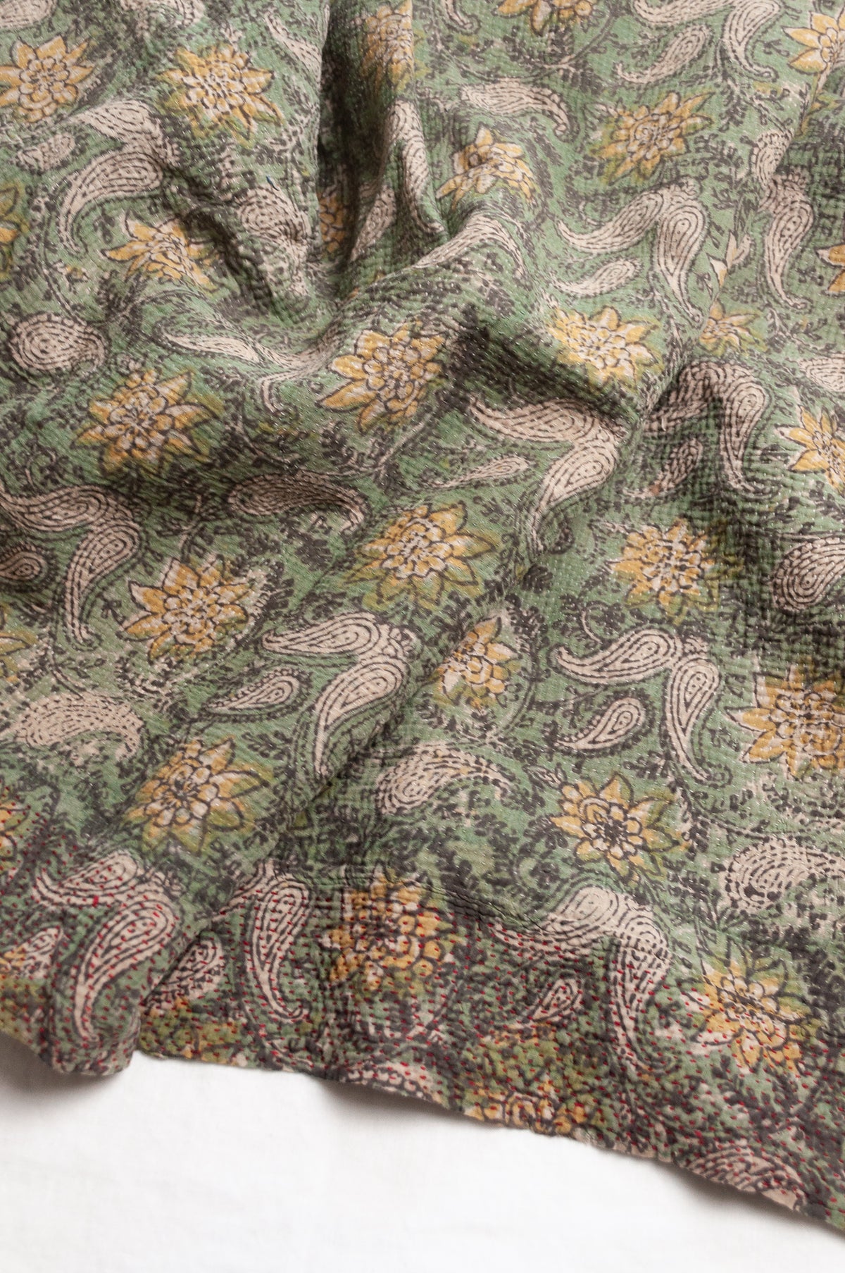 Vintage kantha quilt Bagru blockprinted in sage green, floral design with red braid edging embroidery.