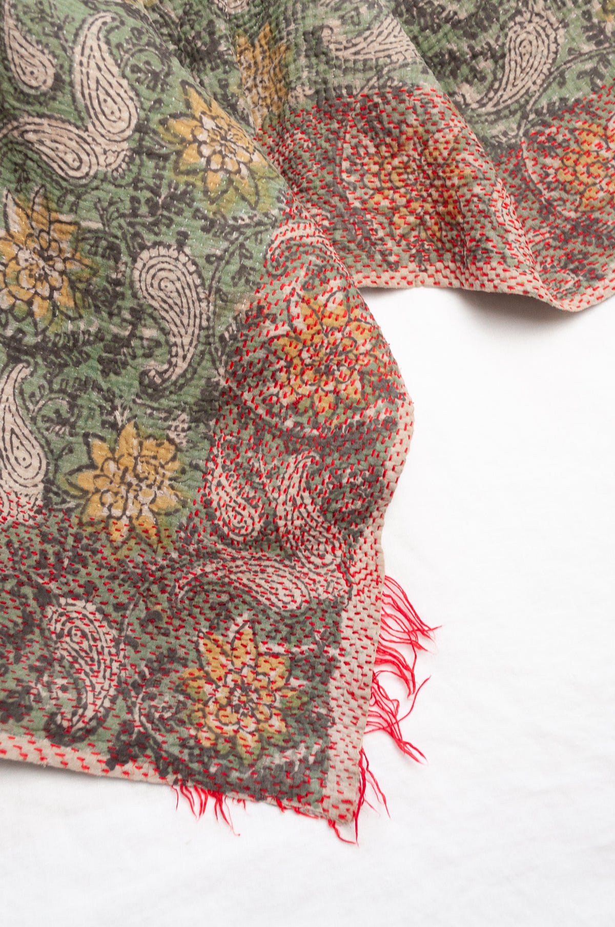 Vintage kantha quilt Bagru blockprinted in sage green, floral design with red braid edging embroidery.