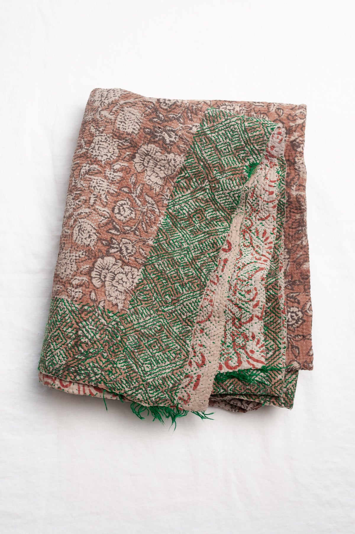 Vintage kantha quilt Bagru blockprinted in brown, floral design with green braid edging embroidery.