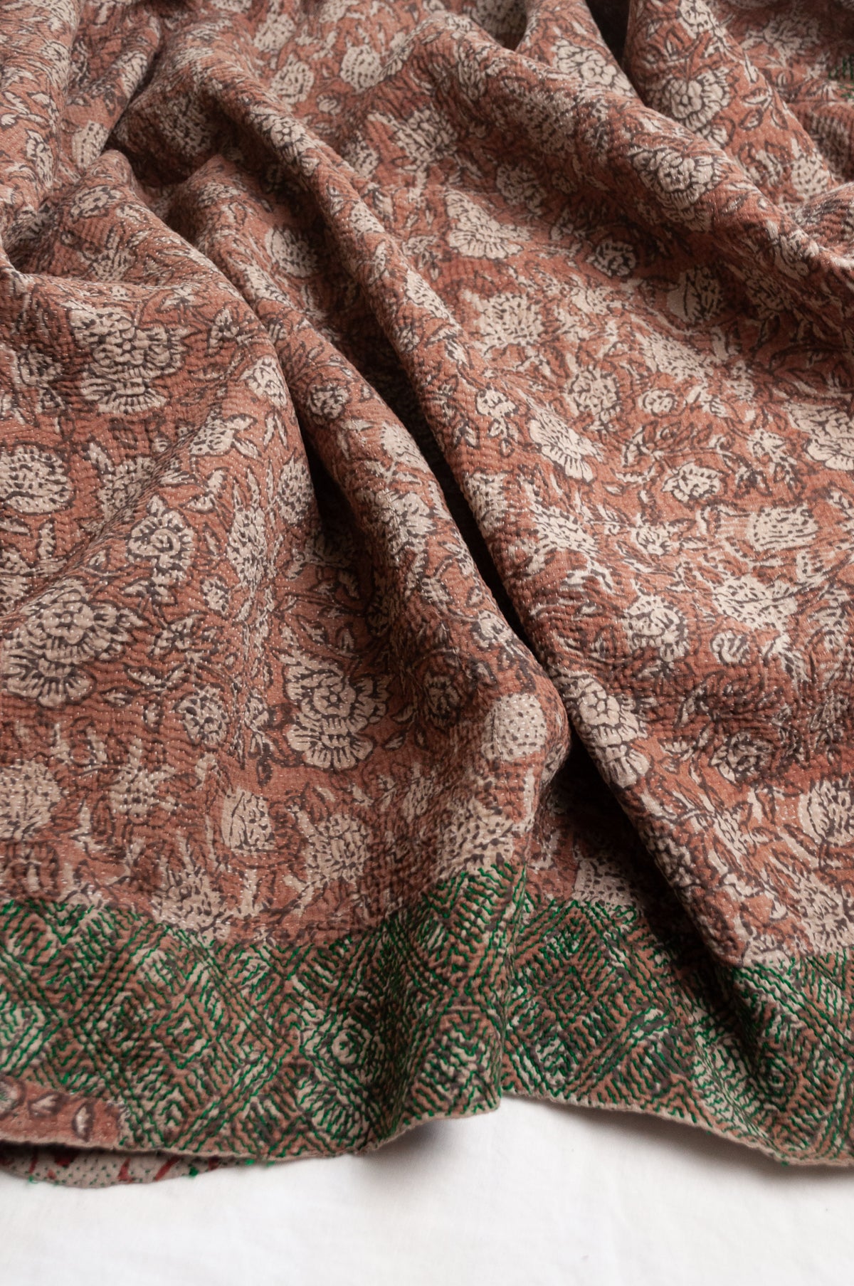 Vintage kantha quilt Bagru blockprinted in brown, floral design with green braid edging embroidery.