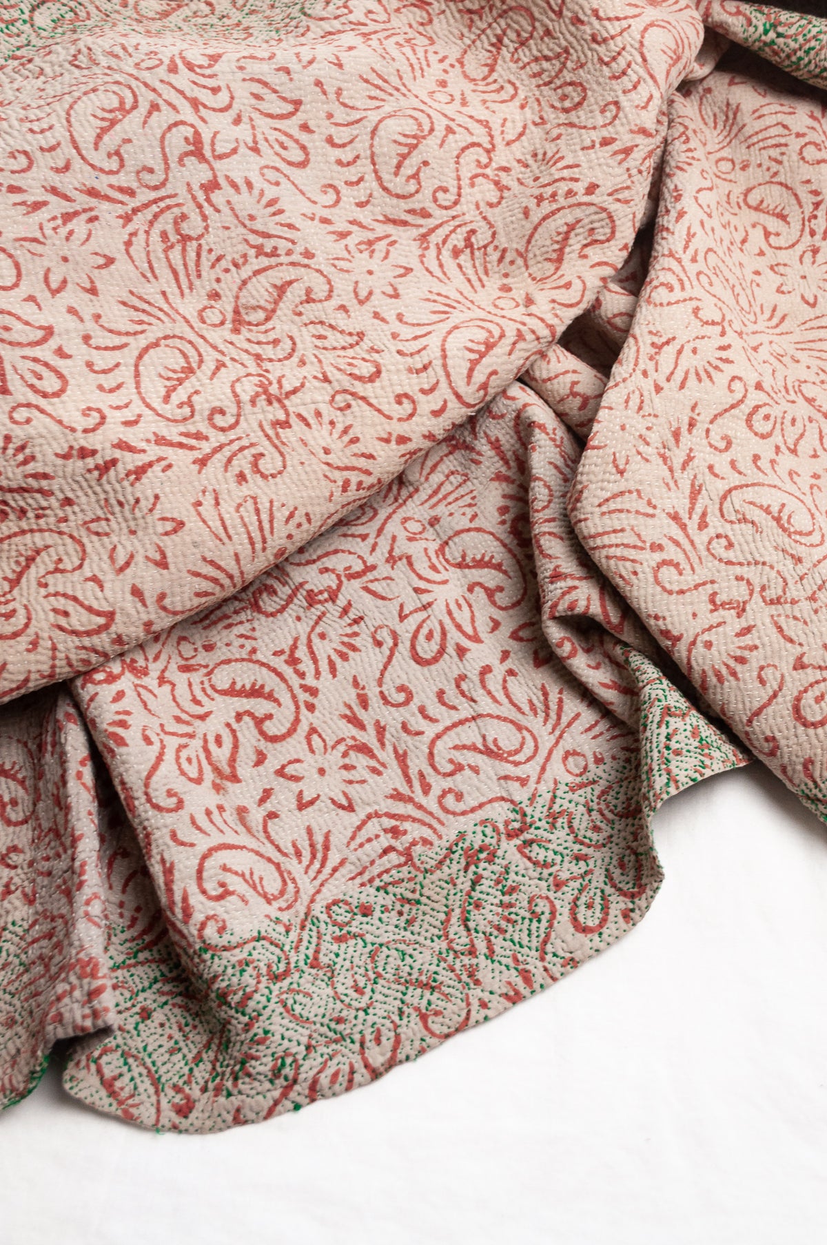 Vintage kantha quilt Bagru blockprinted in brown, floral design with green braid edging embroidery.