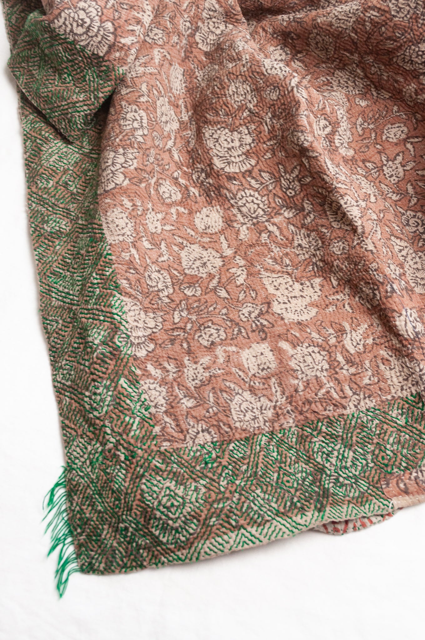 Vintage kantha quilt Bagru blockprinted in brown, floral design with green braid edging embroidery.