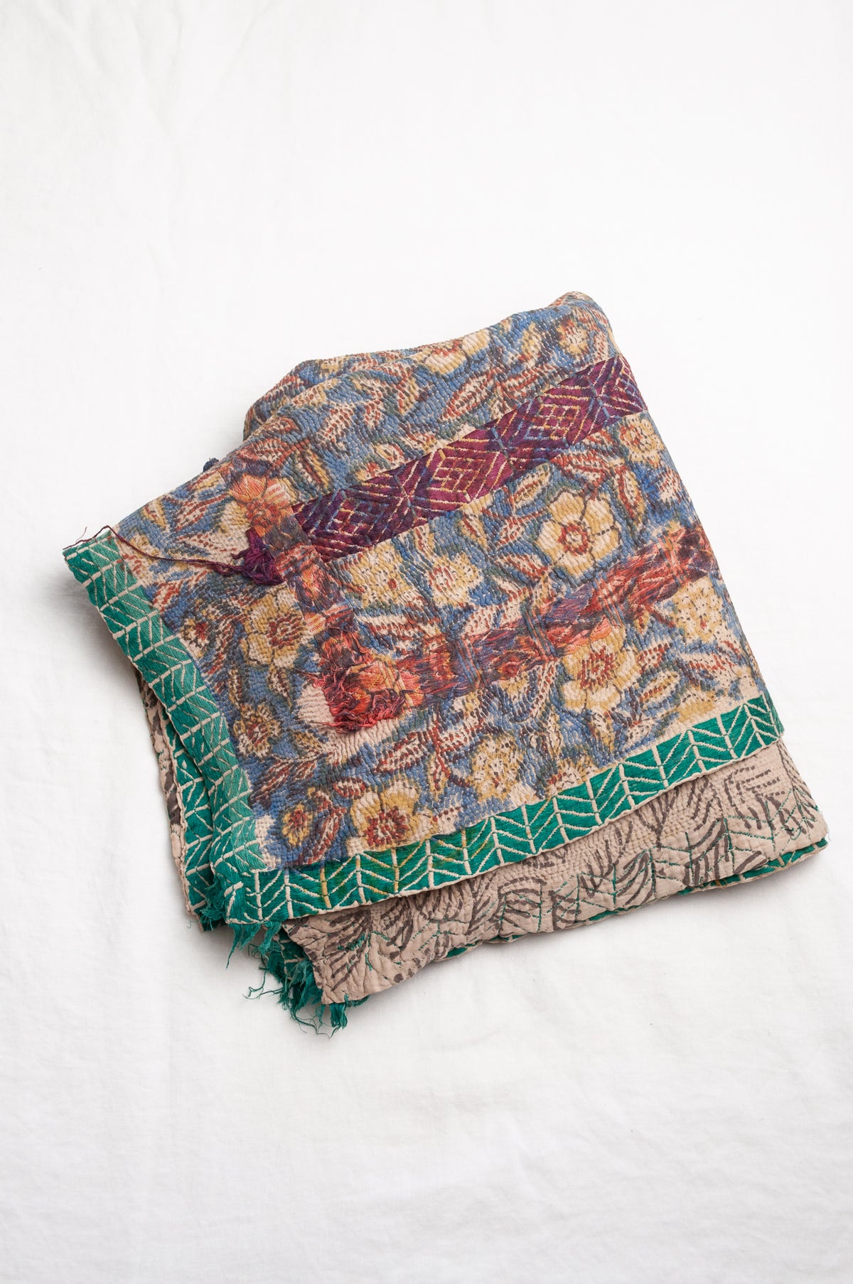 Vintage kantha quilt Bagru blockprinted in indigo, floral design with red, blue and green braid embroidery.