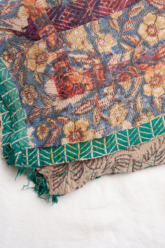 Vintage kantha quilt Bagru blockprinted in indigo, floral design with red, blue and green braid embroidery.