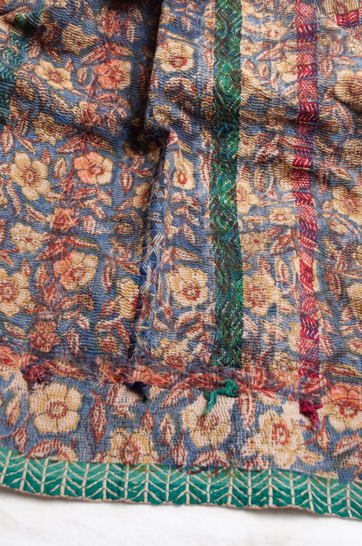 Vintage kantha quilt Bagru blockprinted in indigo, floral design with red, blue and green braid embroidery.