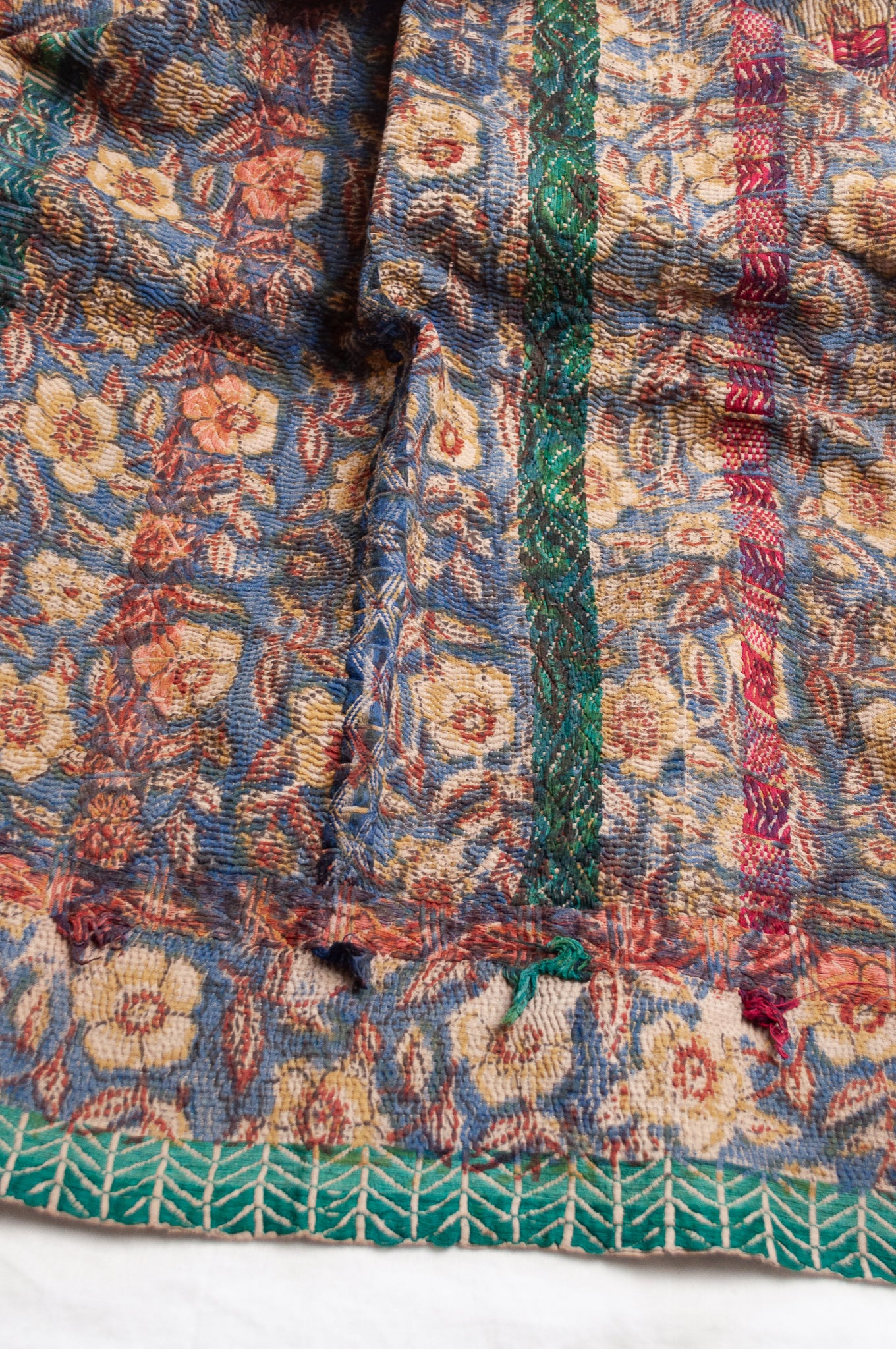 Vintage kantha quilt Bagru blockprinted in indigo, floral design with red, blue and green braid embroidery.