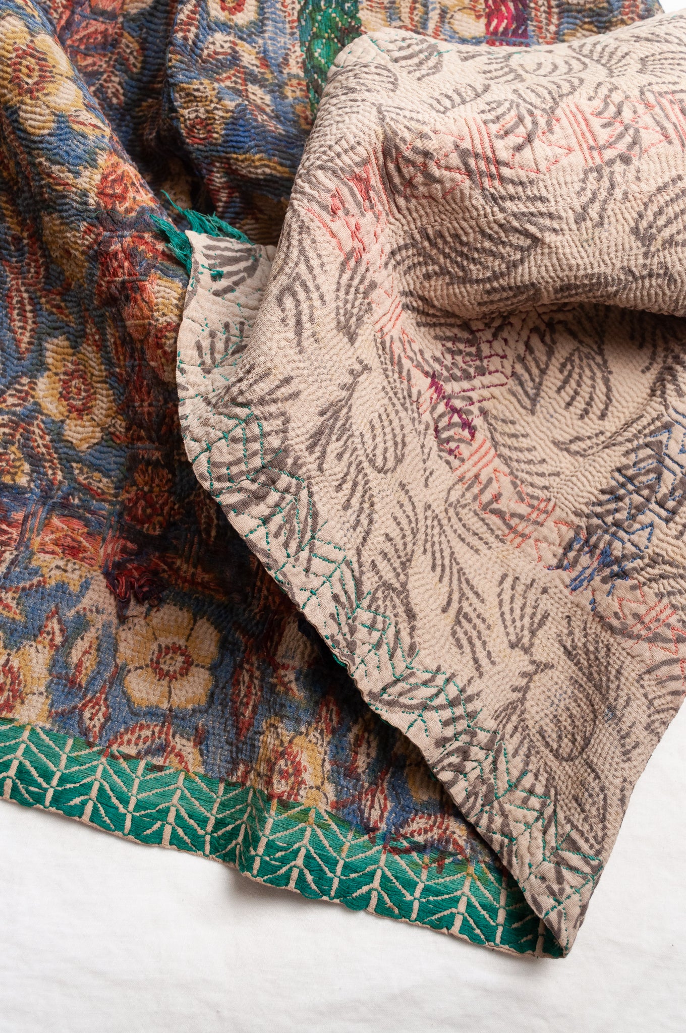 Vintage kantha quilt Bagru blockprinted in indigo, floral design with red, blue and green braid embroidery.