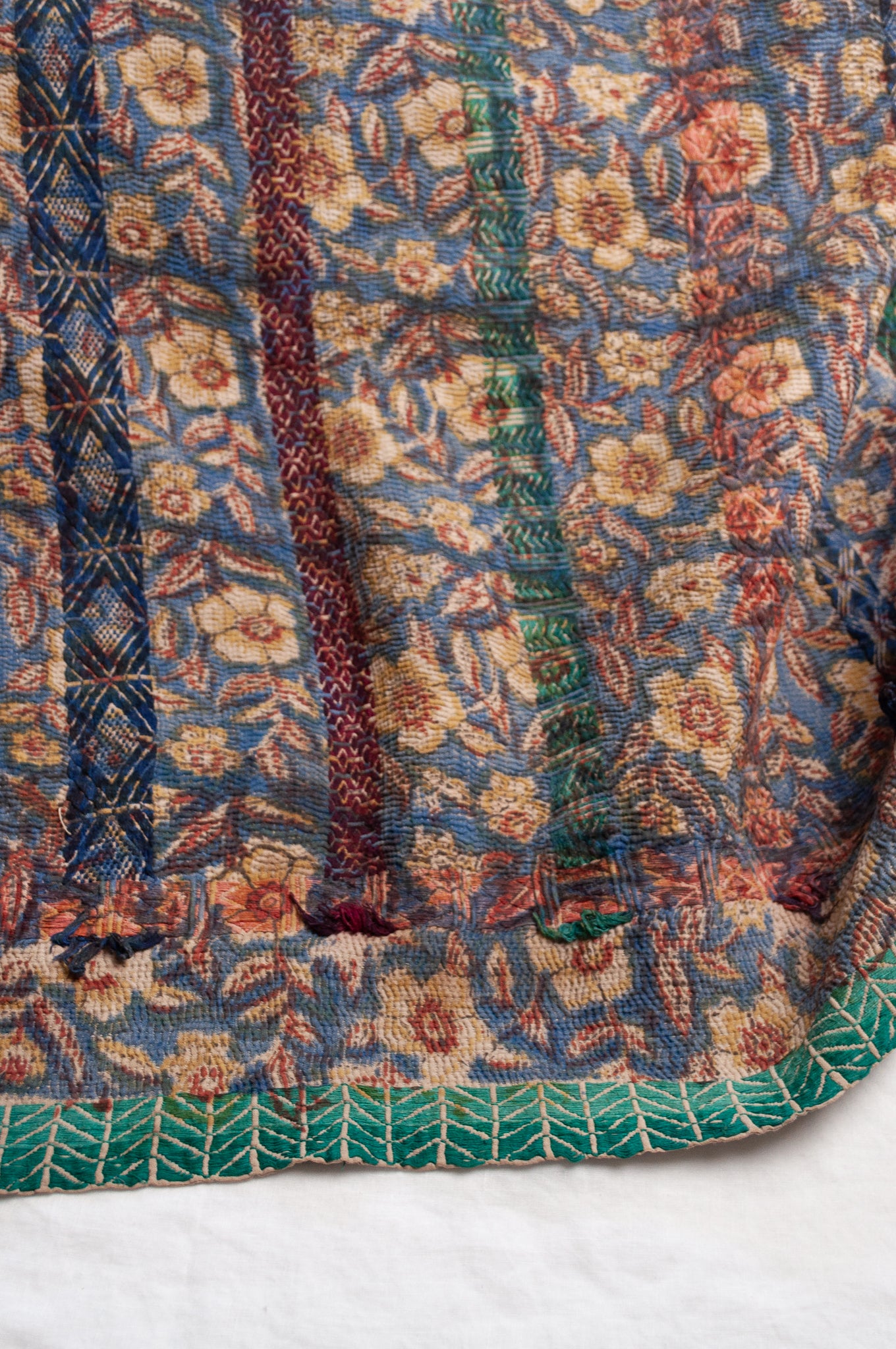 Vintage kantha quilt Bagru blockprinted in indigo, floral design with red, blue and green braid embroidery.