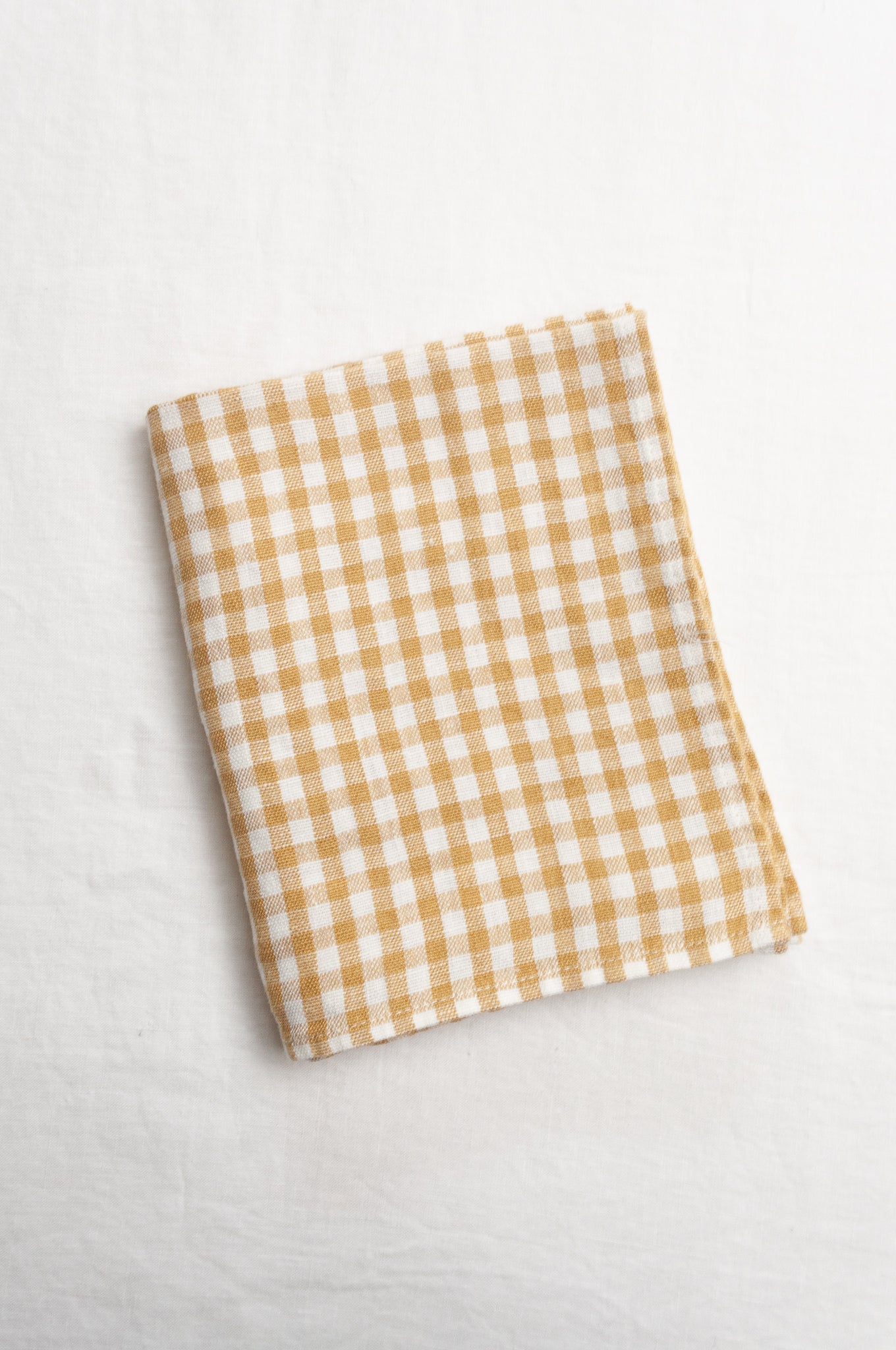 Made in Lituhuania pure linen gingham tea towel in mustard yellow and white.