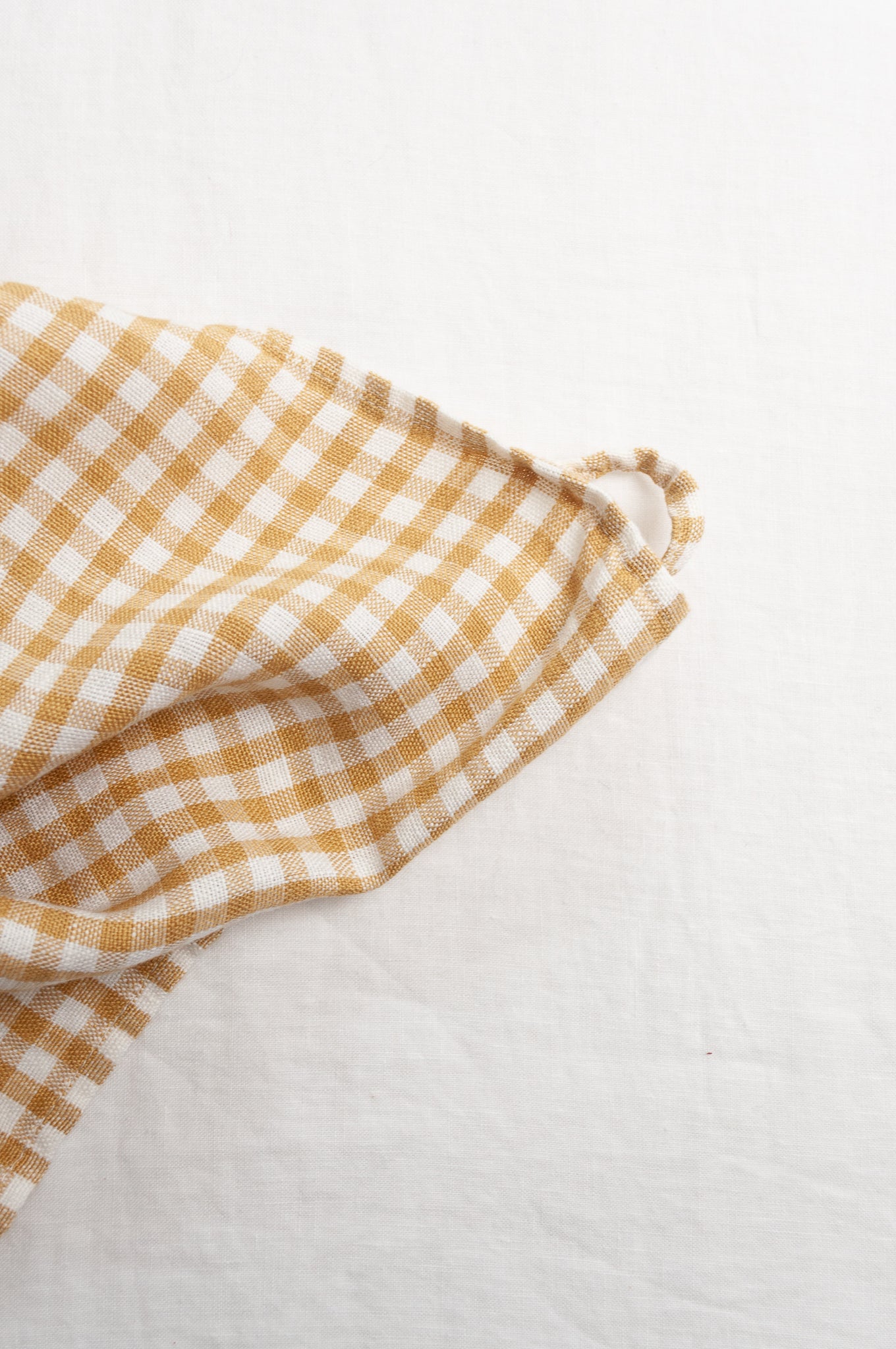 Made in Lituhuania pure linen gingham tea towel in mustard yellow and white.