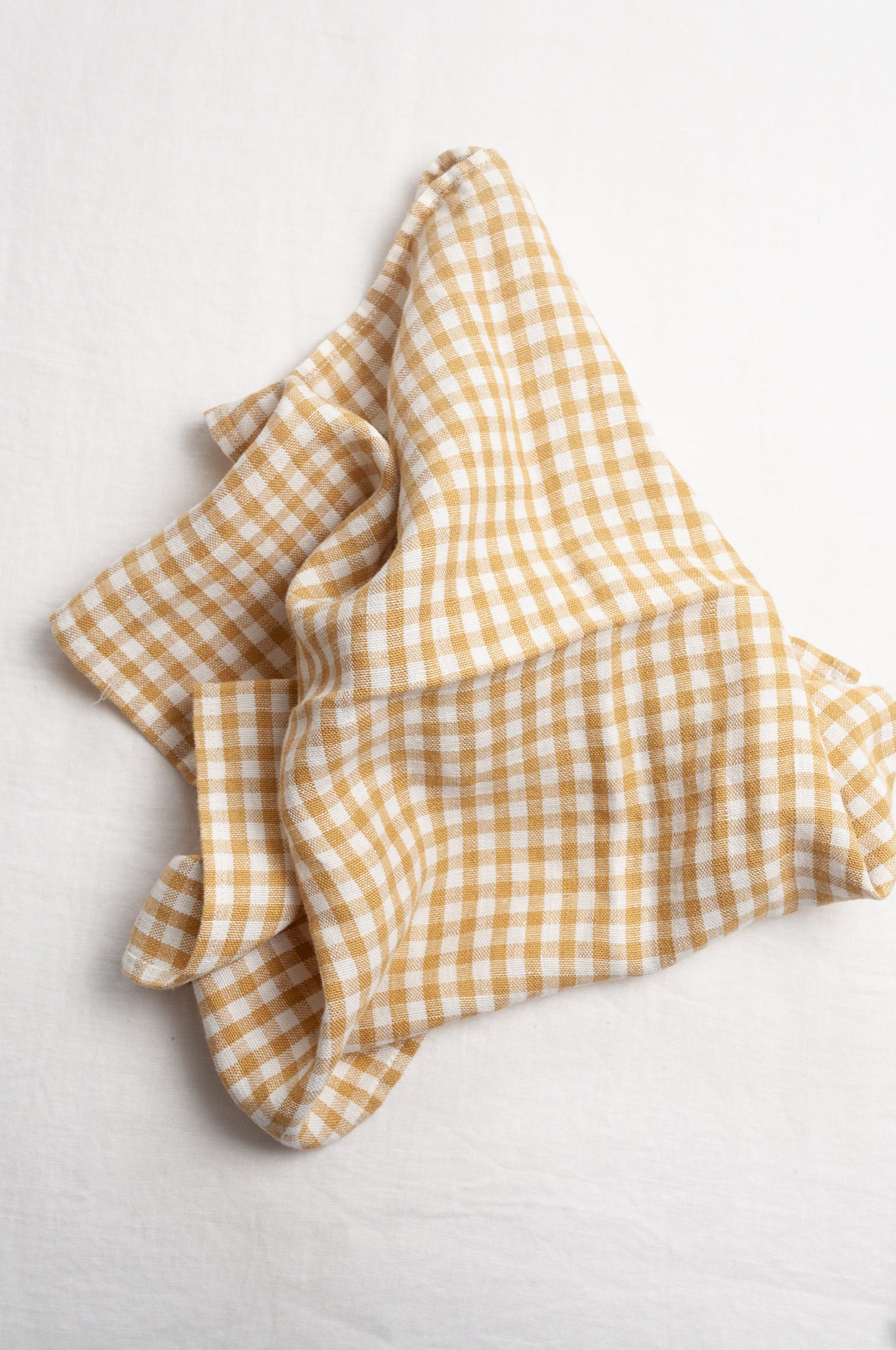 Made in Lituhuania pure linen gingham tea towel in mustard yellow and white.