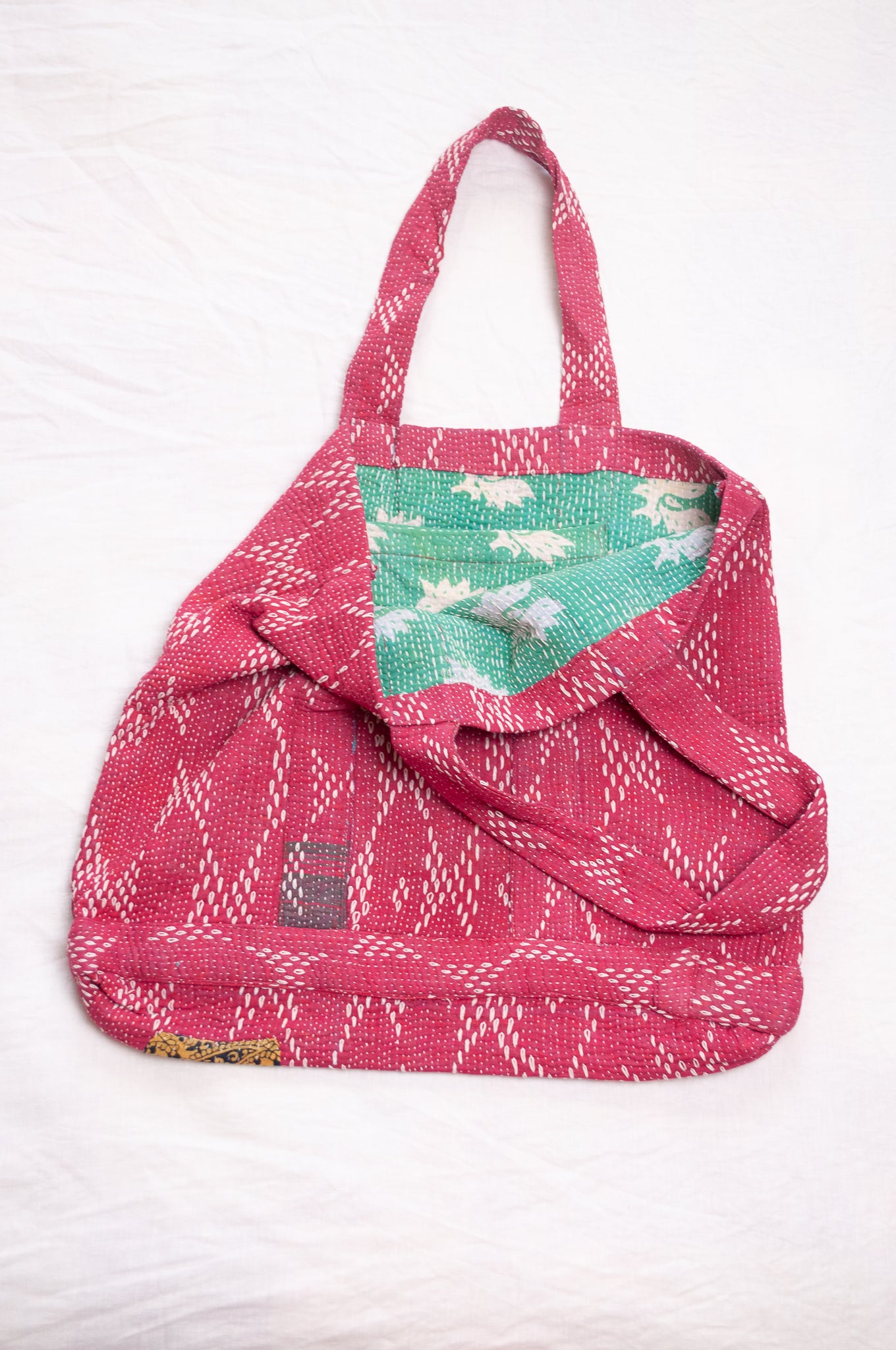 Vintage embroidered kantha quilt market tote bag in raspberry red.