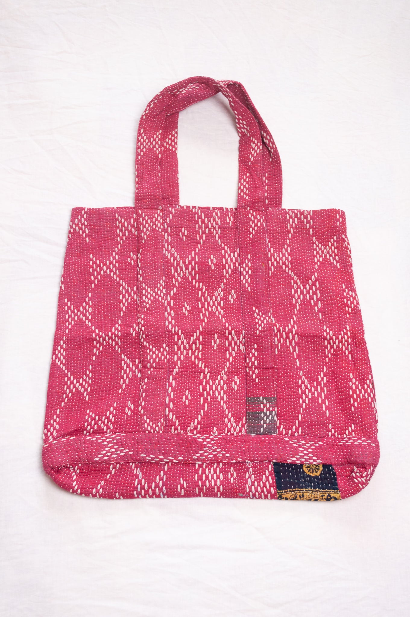 Vintage embroidered kantha quilt market tote bag in raspberry red.