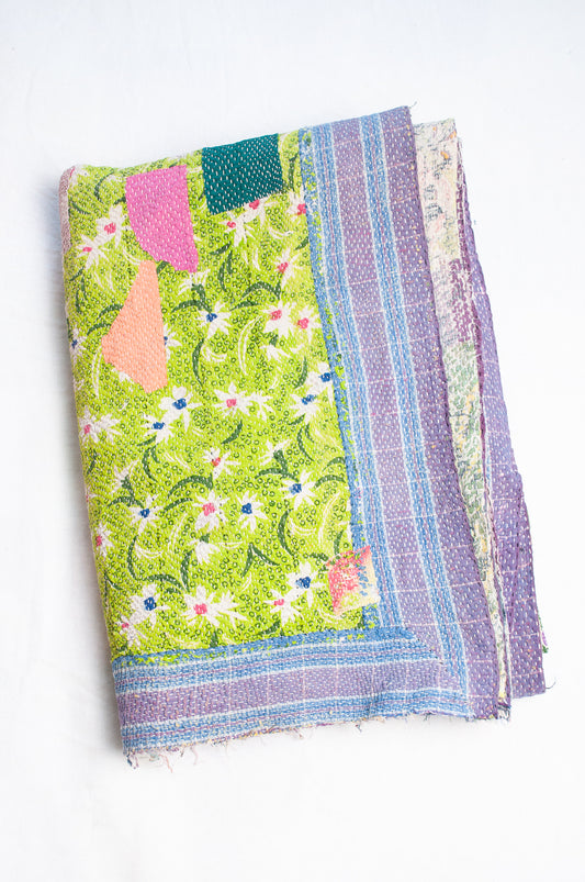 Colourful patchwork kantha quilt featuring cheerful retro prints.