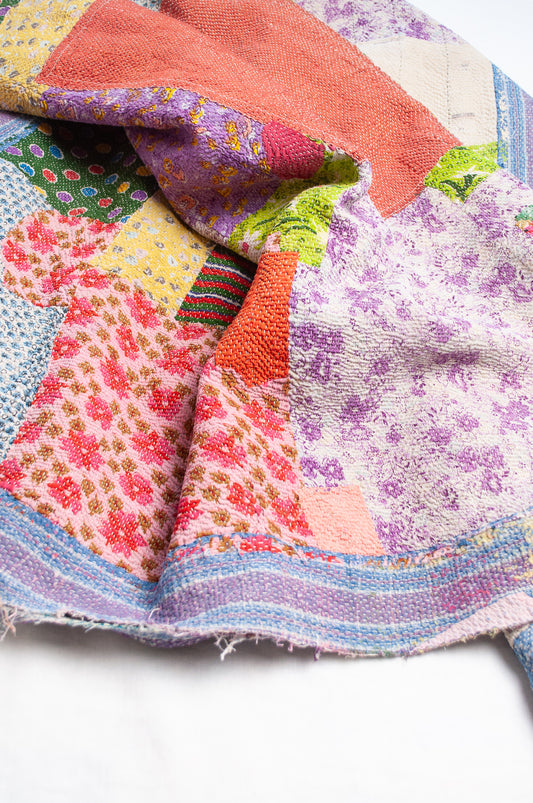 Colourful patchwork kantha quilt featuring cheerful retro prints.