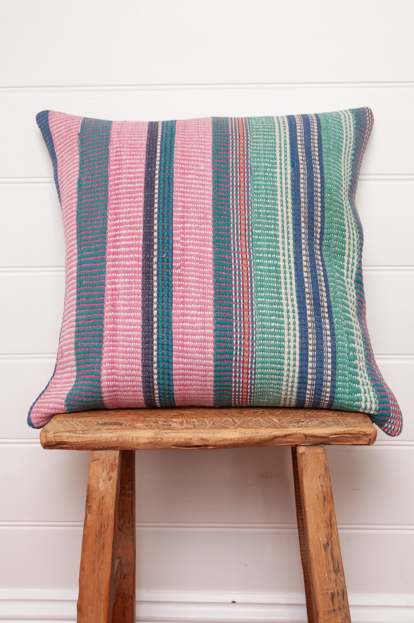 Vintage kantha cushion with stripes in pink, blue and green, finely stitched.