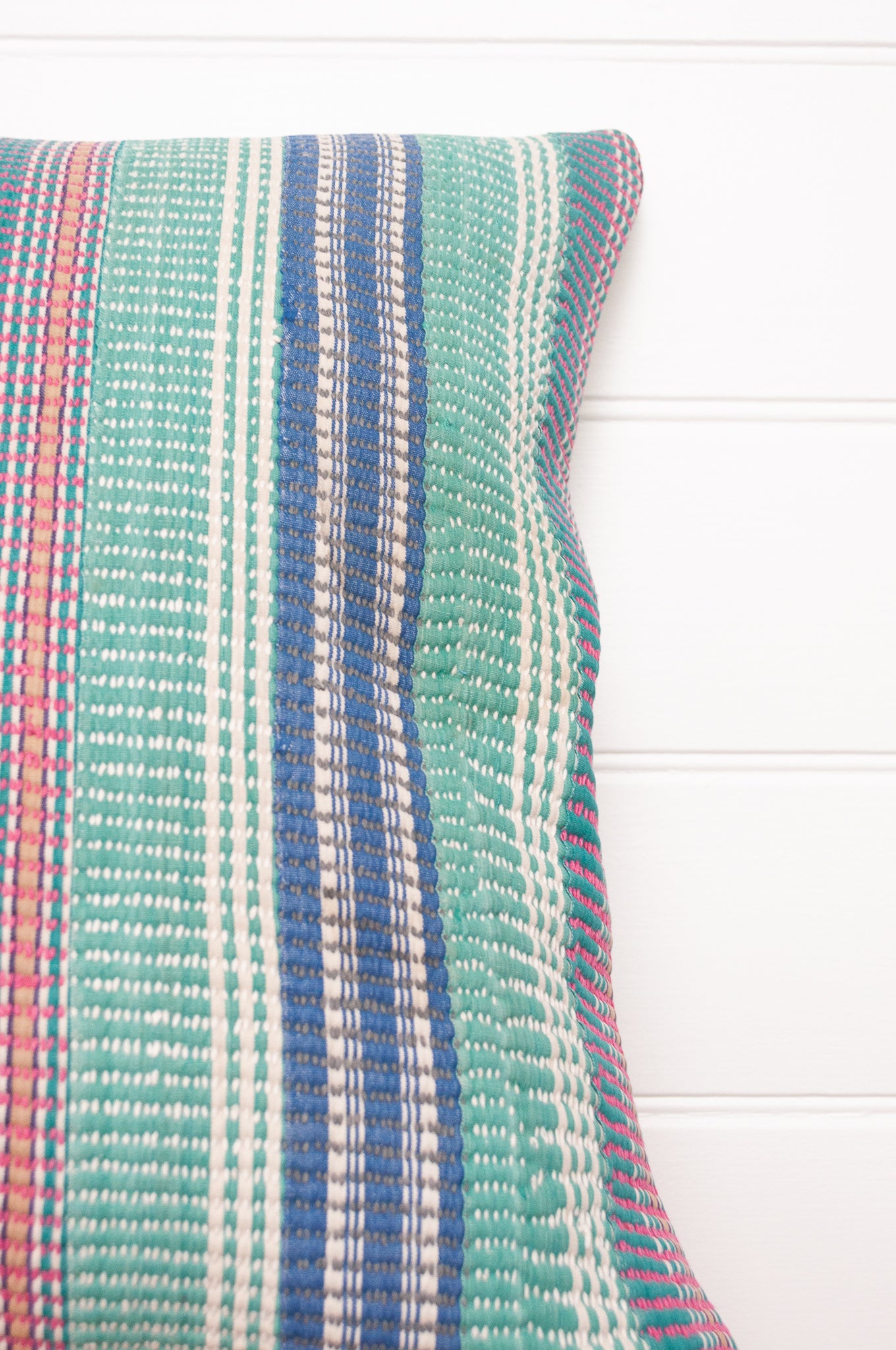 Vintage kantha cushion with stripes in pink, blue and green, finely stitched.