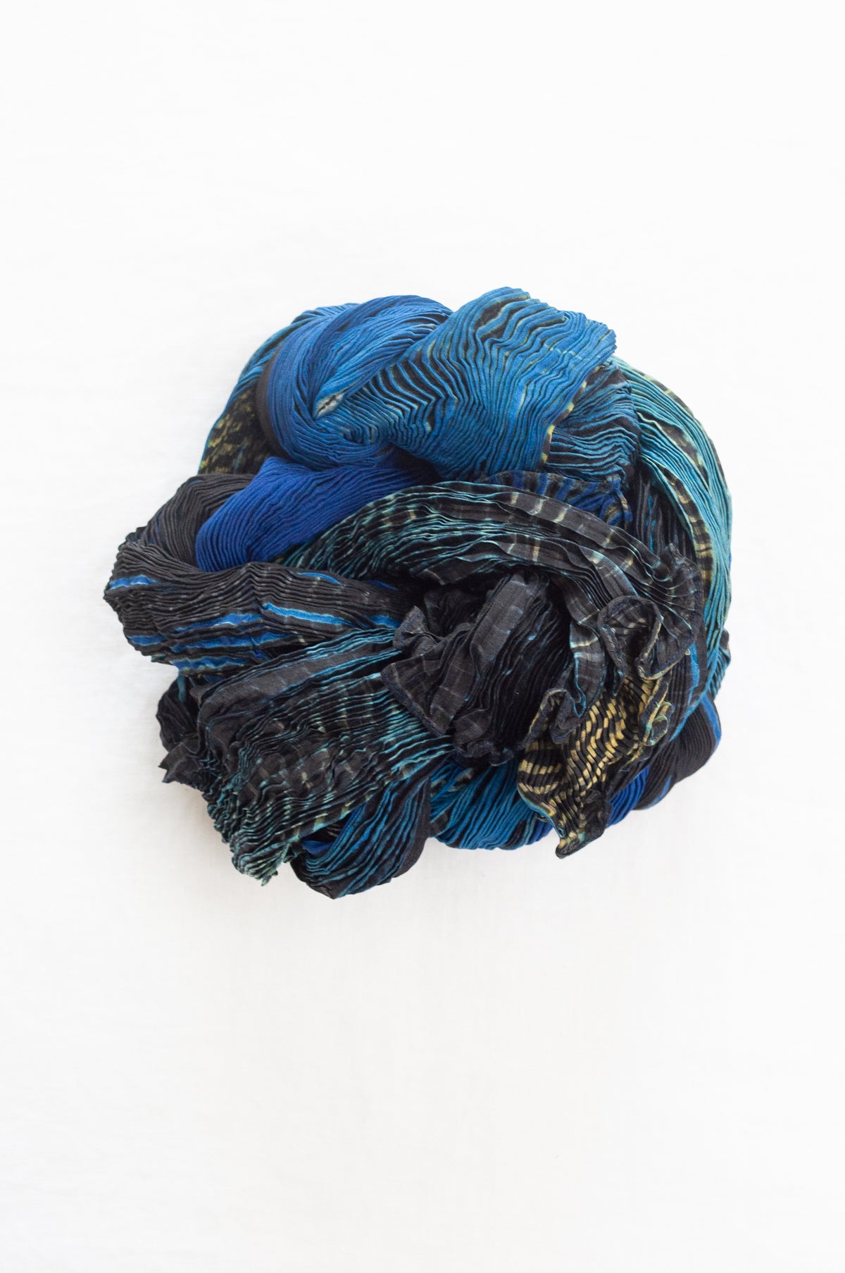 Neeru Kumar shibori dyed pure silk crinkle scarf in blues and greens with black and white speckled details.
