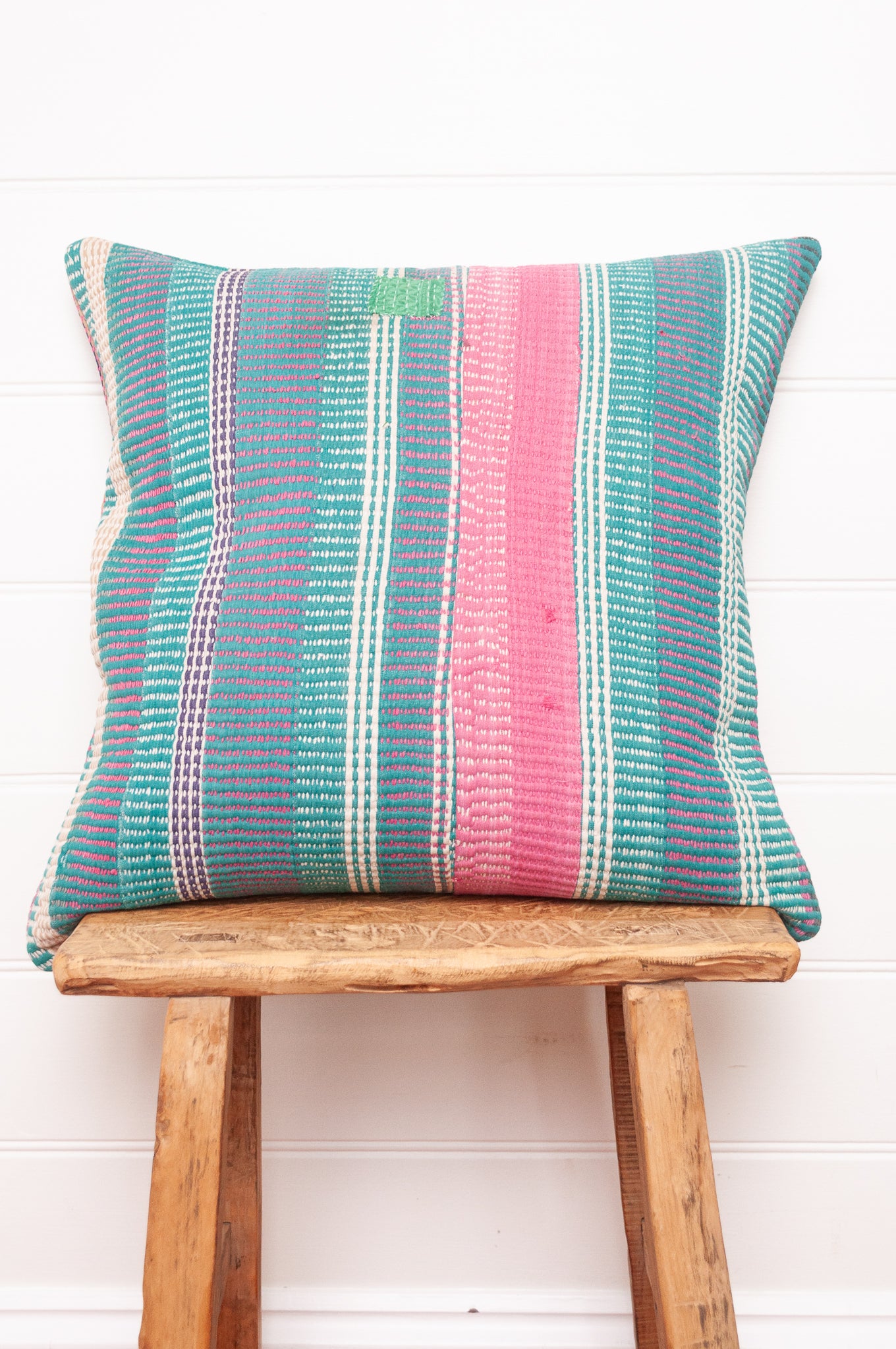 Vintage kantha cushion with stripes in pink, blue and green, finely stitched.