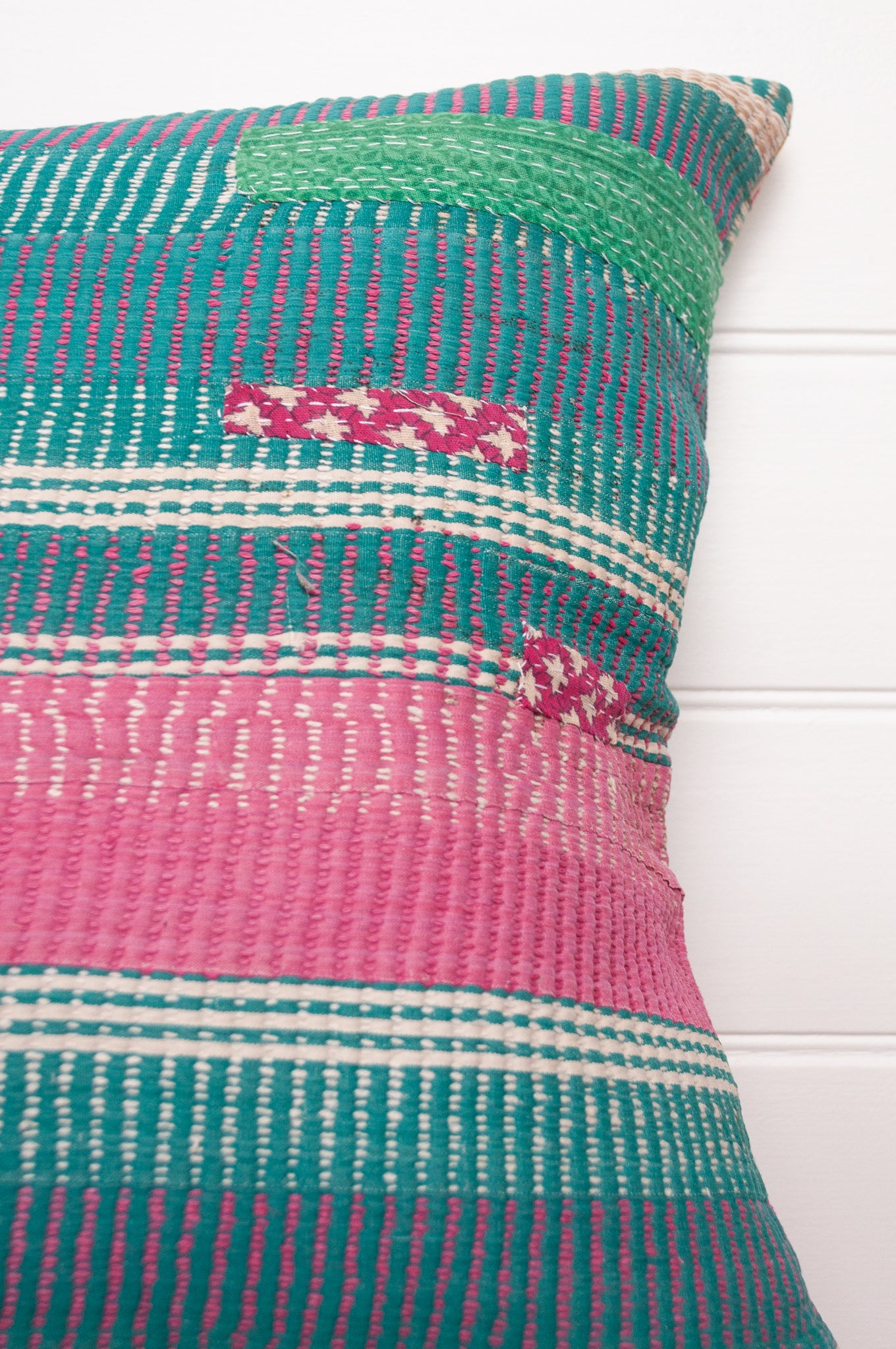Vintage kantha cushion with stripes in pink, blue and green, finely stitched.