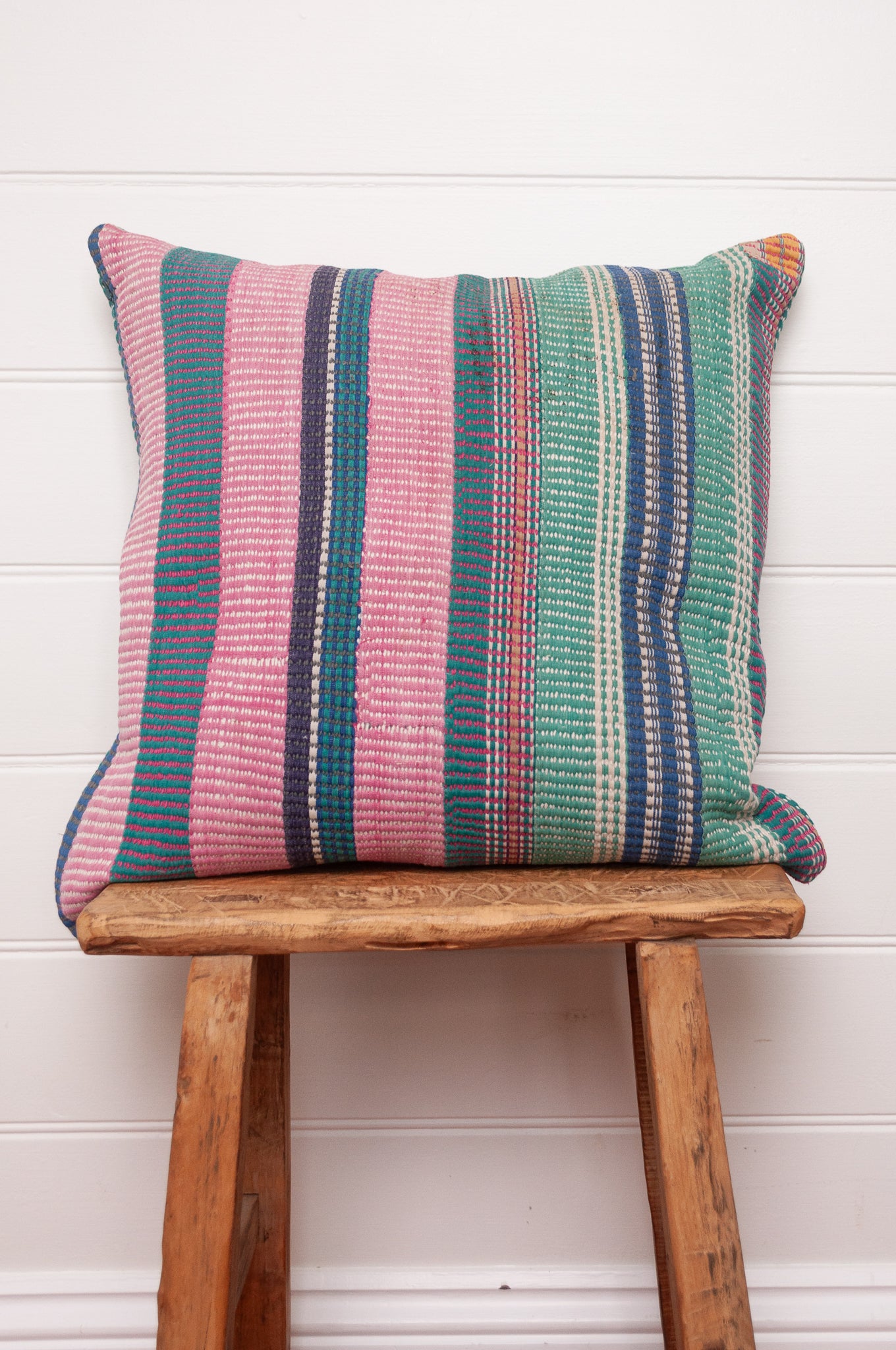 Vintage kantha cushion with stripes in pink, blue and green, finely stitched.